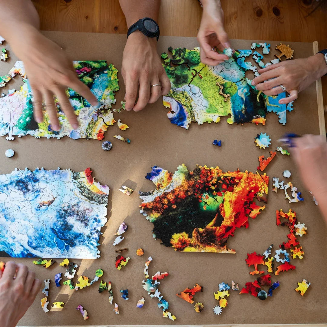 Four people assembling a colorful jigsaw puzzle on a wooden table, vivid nature art pieces.