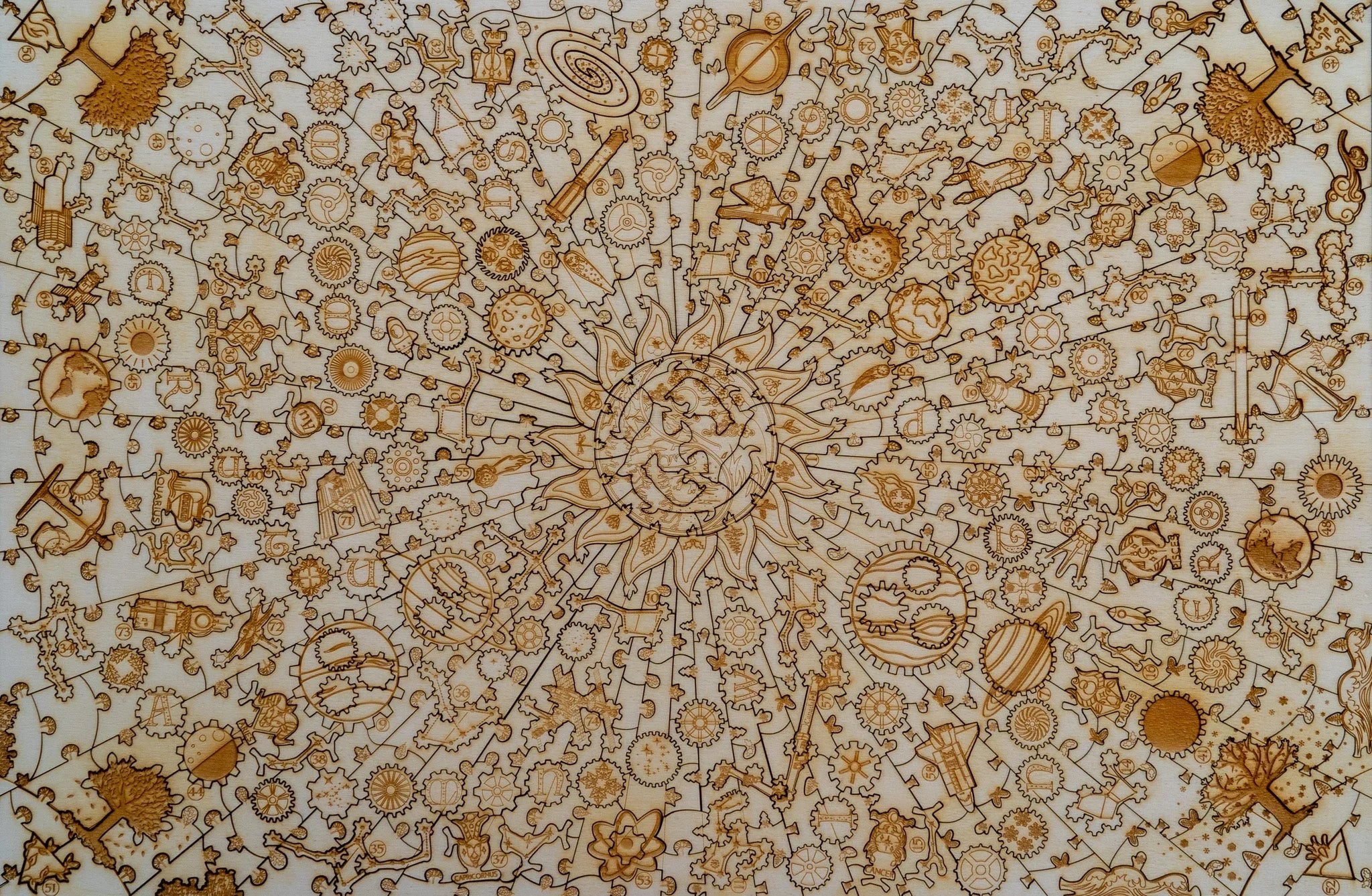 Laser-cut wooden puzzle with intricate gears, sunburst, space and whimsical designs