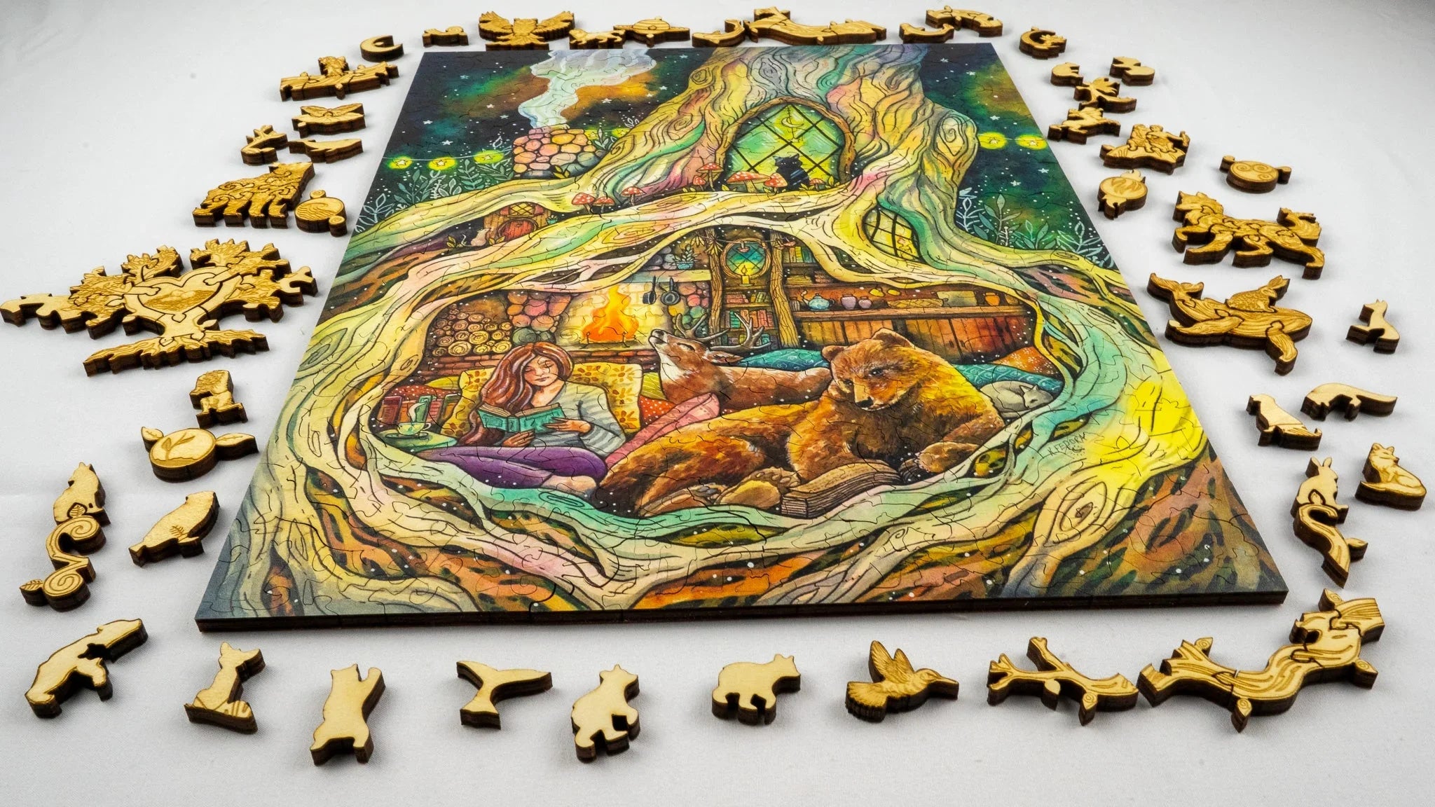 Colorful wooden animal puzzle featuring a cozy forest scene with girl, bear, deer, fireplace.