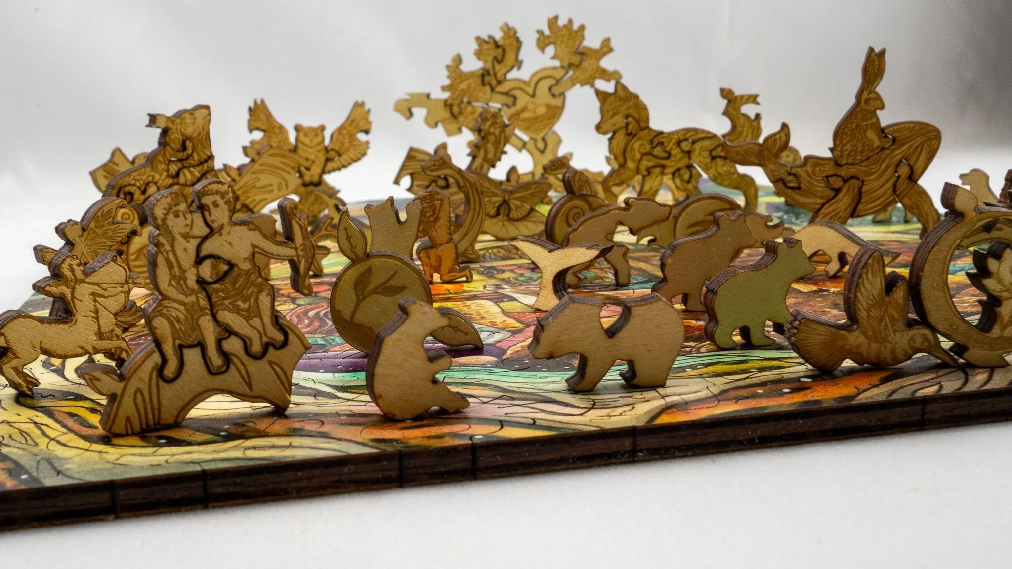 Laser cut wooden animal figures on a colorful wooden jigsaw puzzle