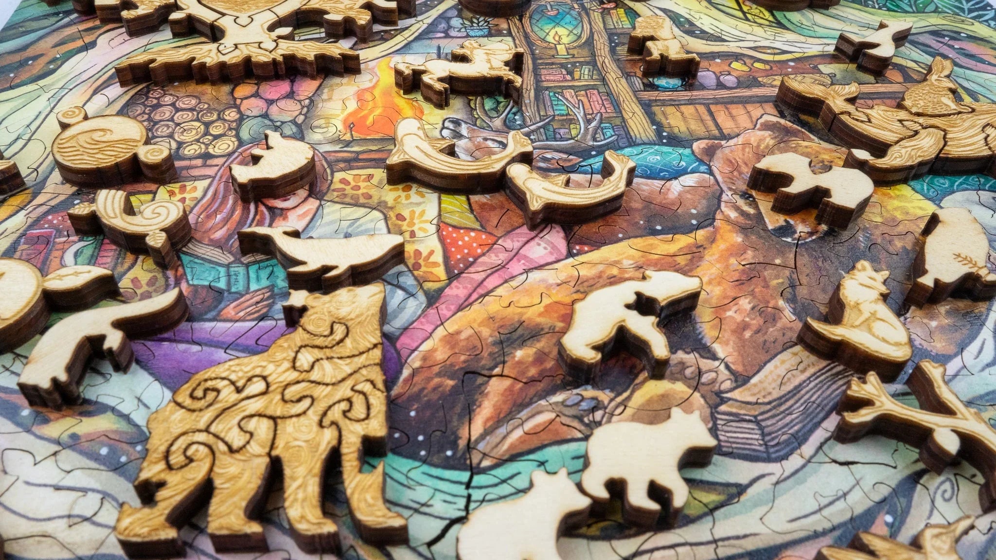 Wooden animal-shaped puzzle pieces on a colorful illustrated jigsaw background