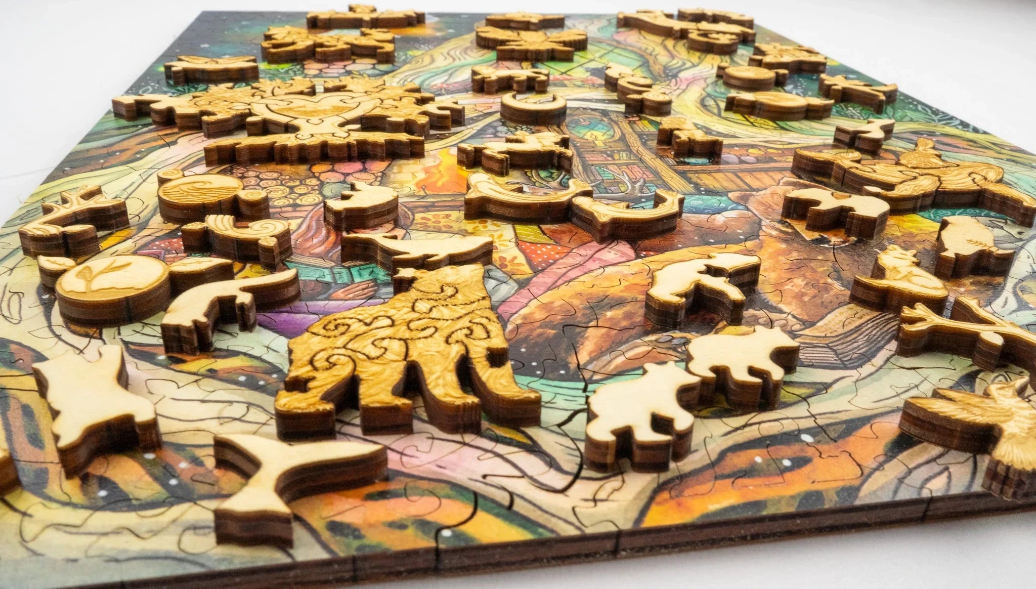 Wooden animal-shaped puzzle pieces on a colorful jigsaw puzzle board