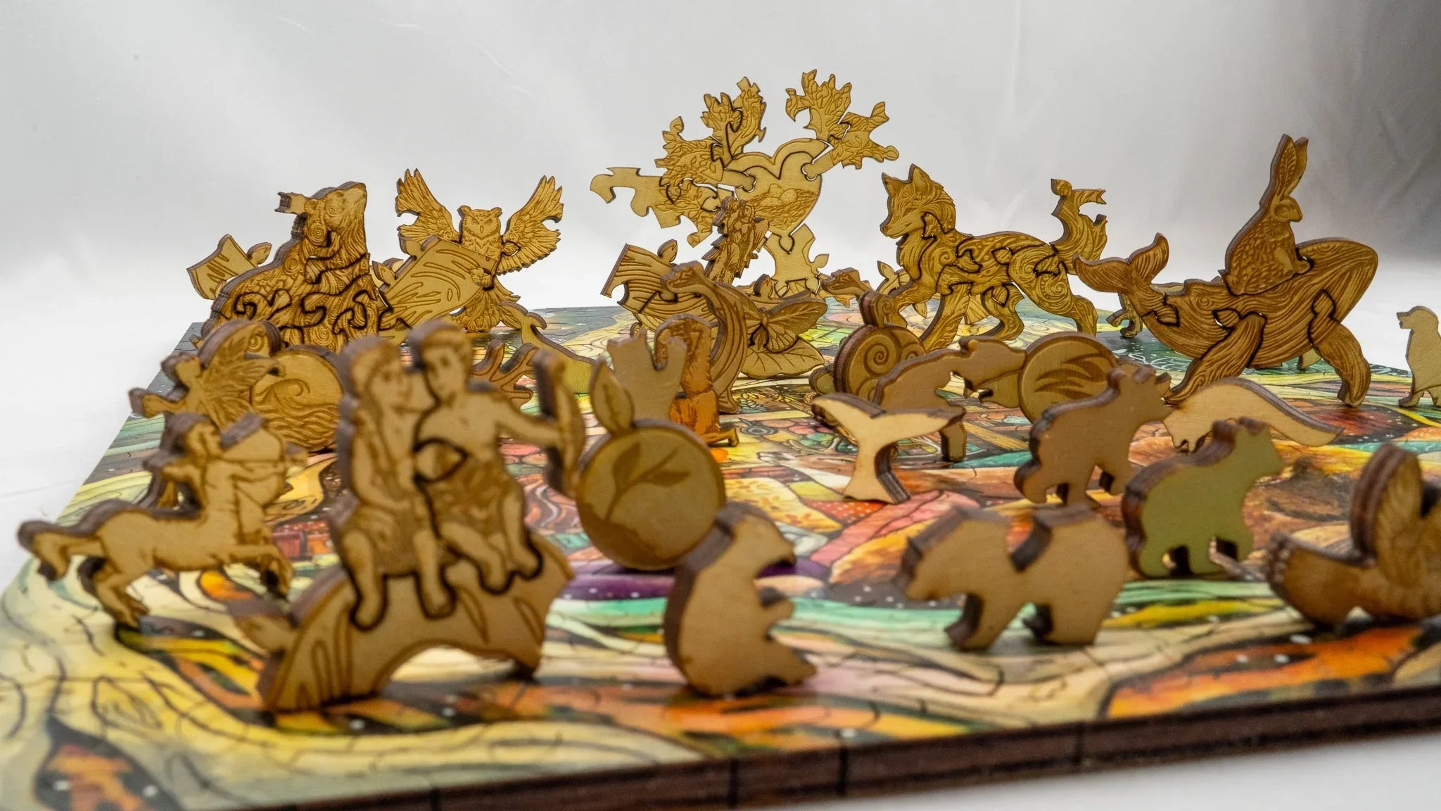 Laser-cut wooden animal puzzle pieces on a colorful board, whimsical animal shapes