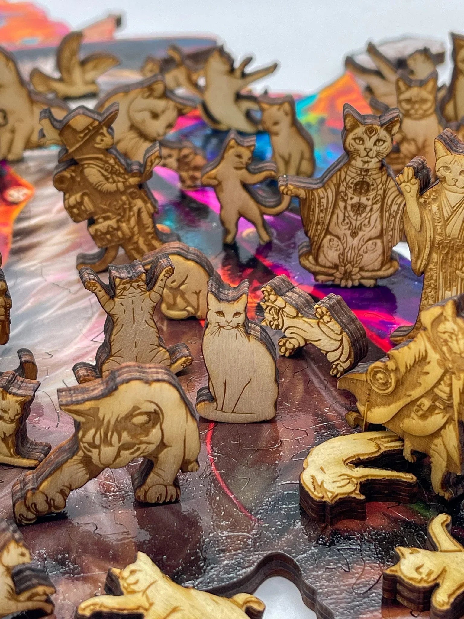 Laser-cut wooden cat puzzle pieces on a colorful jigsaw puzzle background