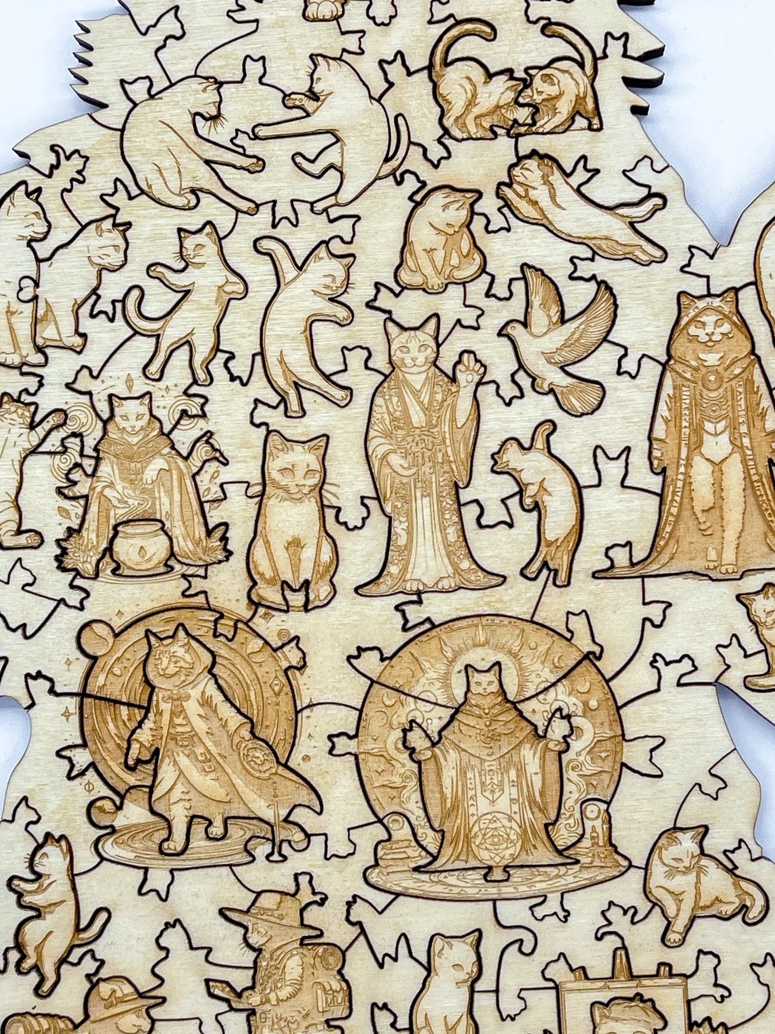 Laser-cut wooden puzzle with engraved cats in playful and magical costumes