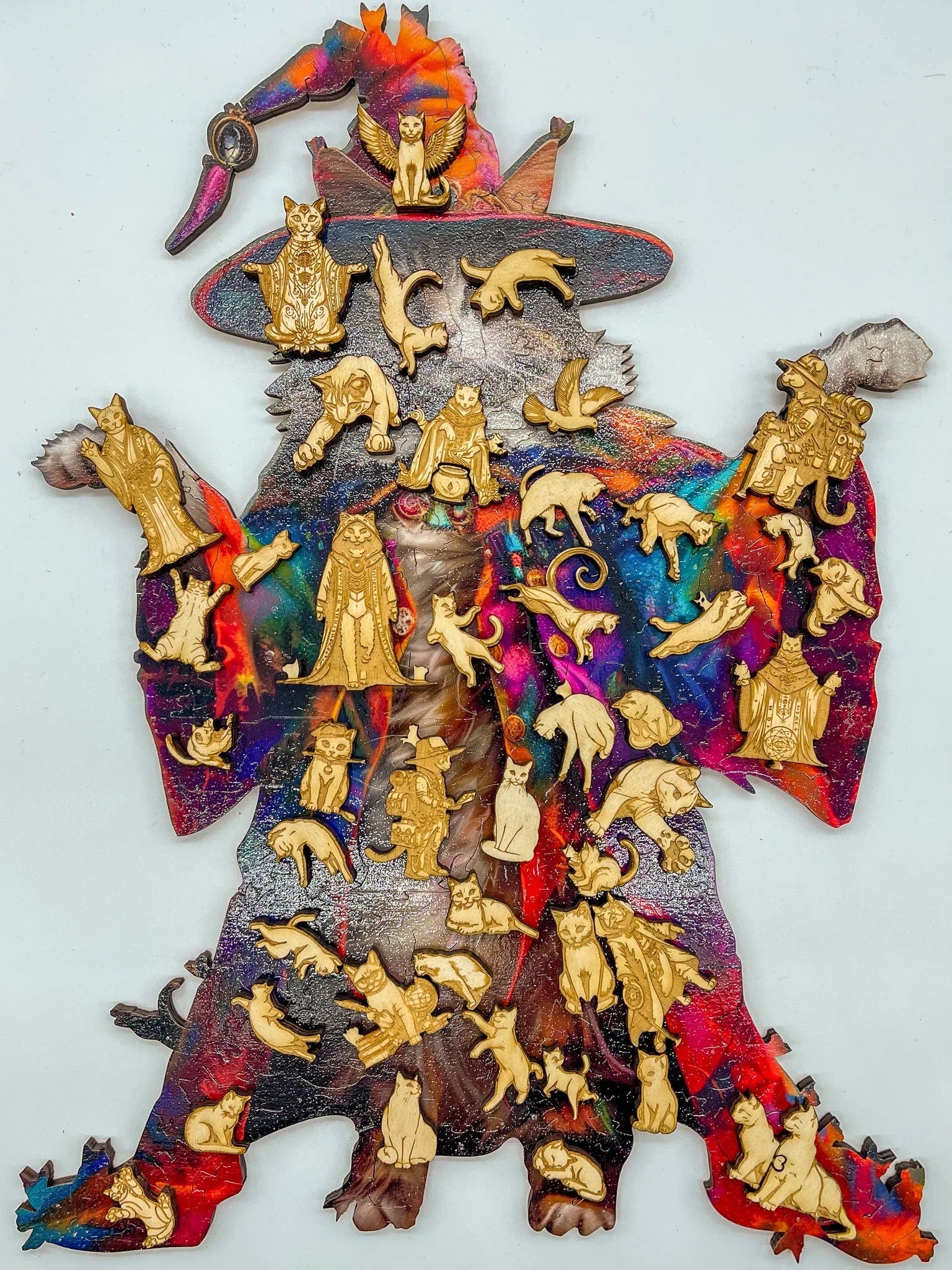 Colorful wizard cat puzzle with wooden cat pieces on white background