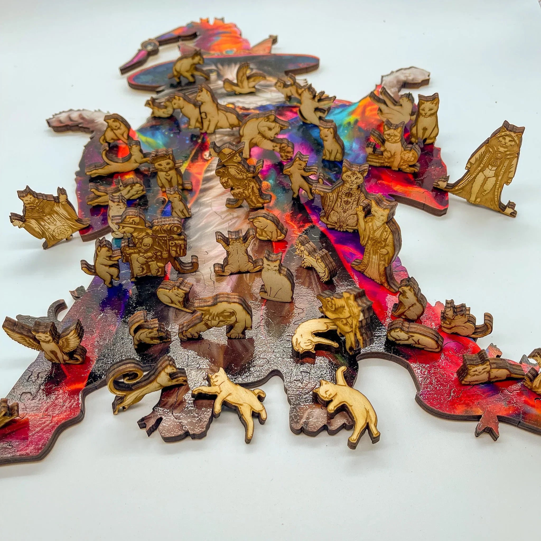 Wooden cat-themed jigsaw puzzle pieces on a colorful wizard silhouette background