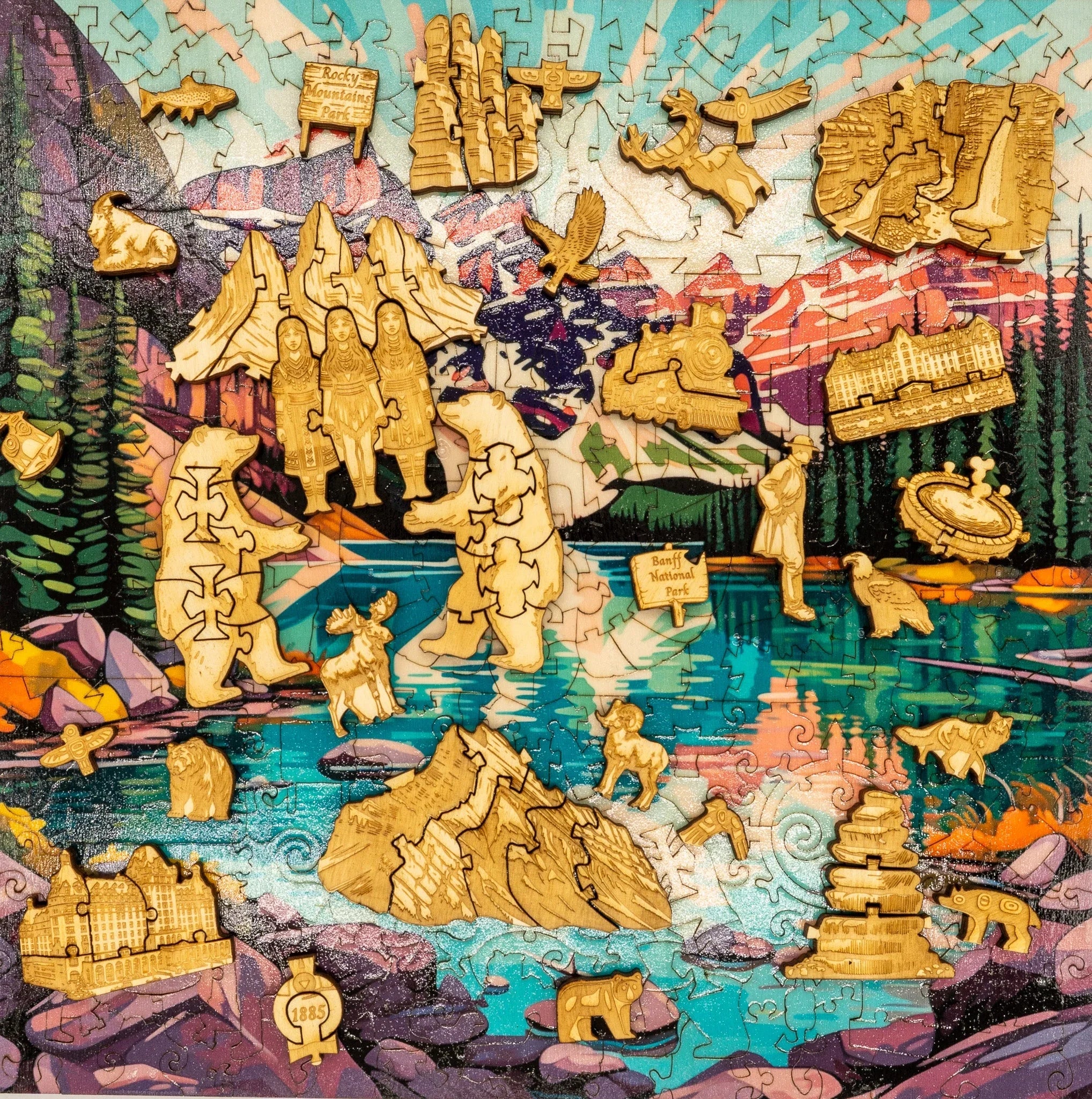 Colorful Banff National Park puzzle with wooden wildlife and landmark pieces by a lake.