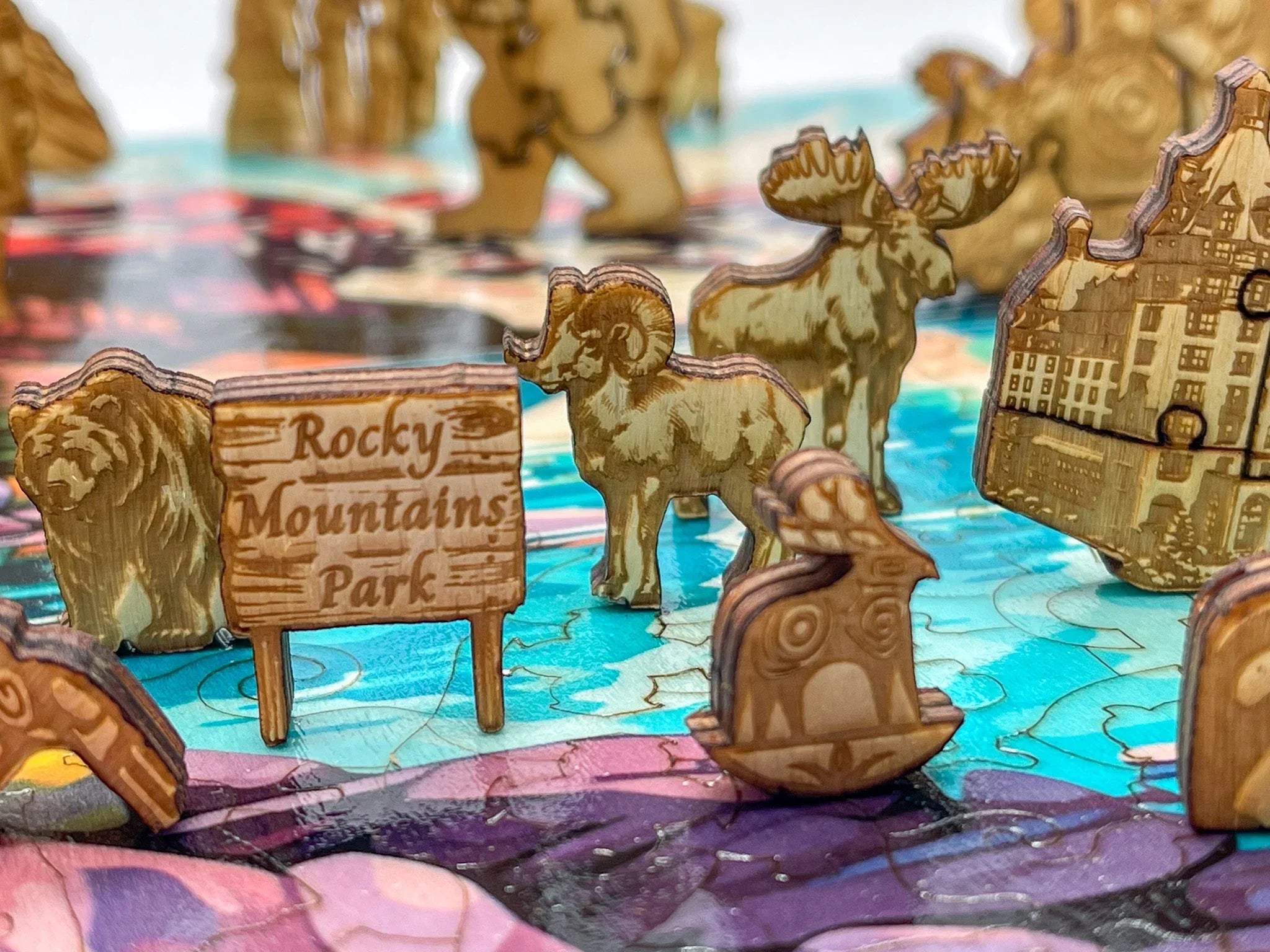 Wooden Rocky Mountains Park puzzle pieces with bear, moose, ram, and detailed animal shapes