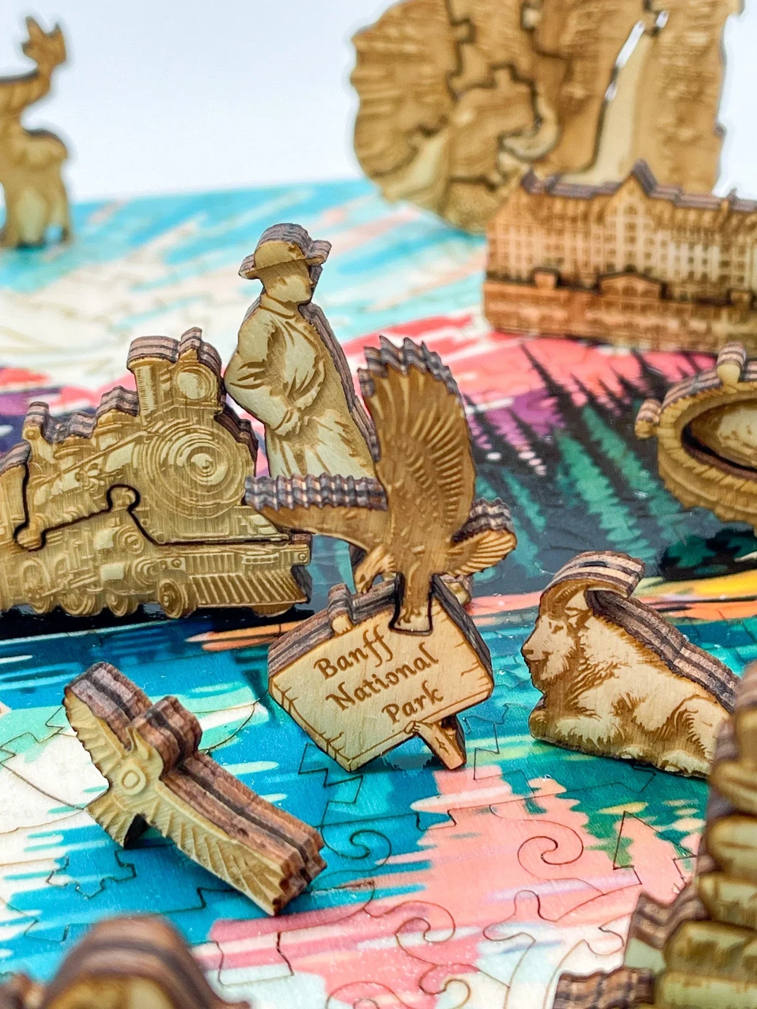 Wooden Banff National Park puzzle pieces on colorful background, featuring wildlife and landmarks