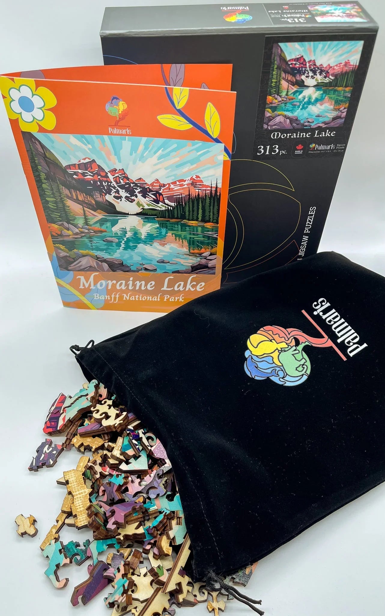 Moraine Lake Banff National Park jigsaw puzzle with colorful pieces, box, and velvet bag.