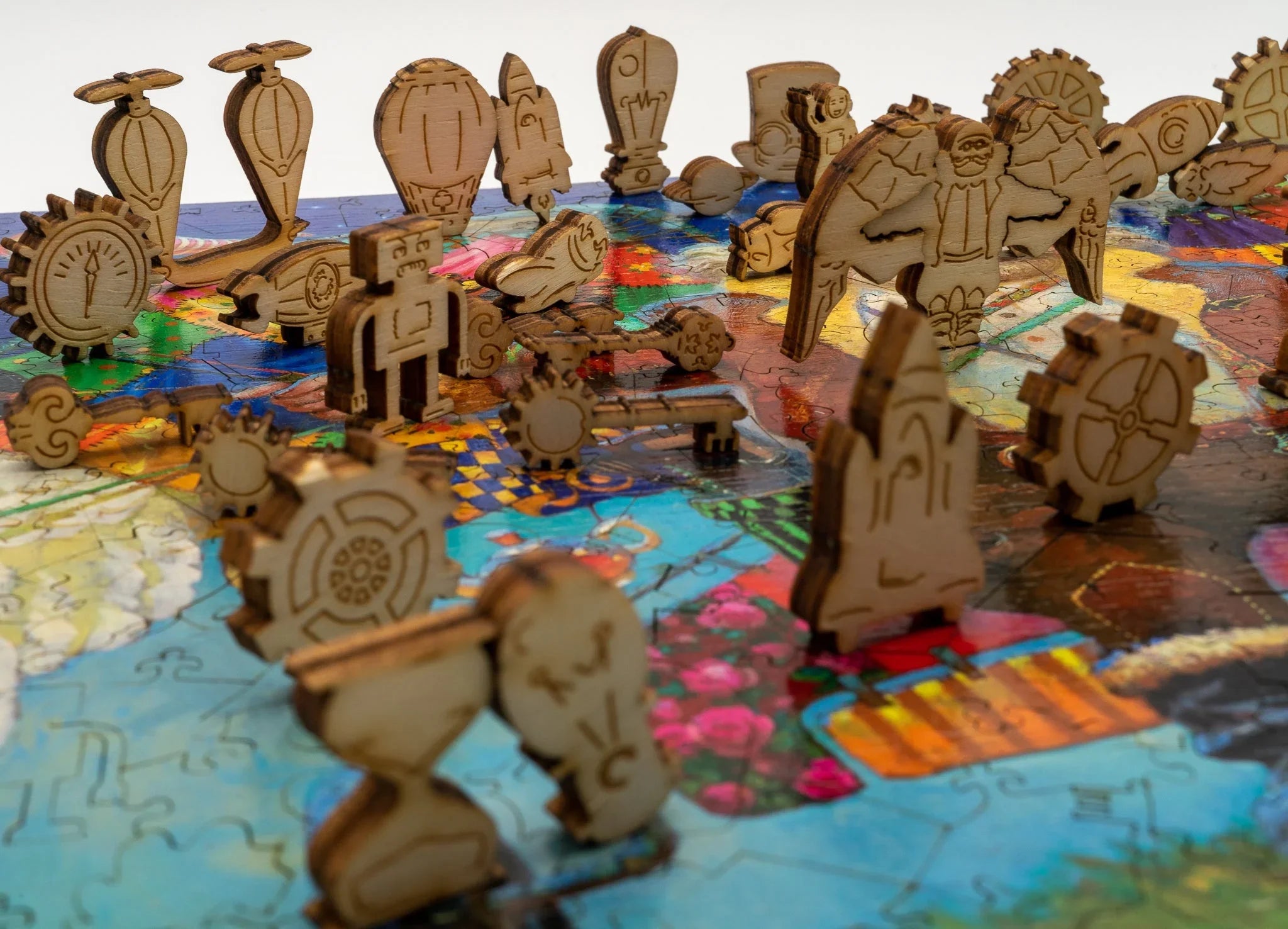 Laser-cut wooden puzzle pieces shaped as gears, robots, and steampunk objects on a colorful puzzle board