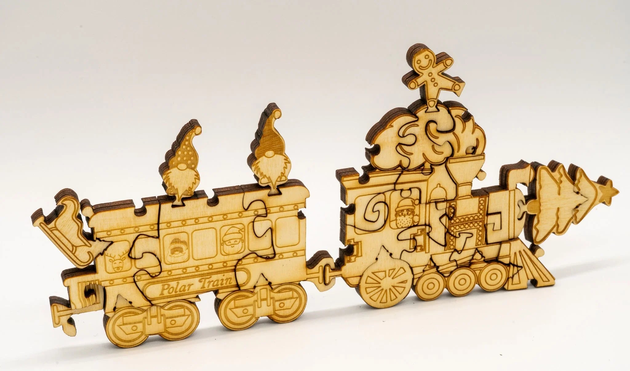 Wooden Polar Train puzzle with gnomes, gingerbread figure, and Christmas tree details