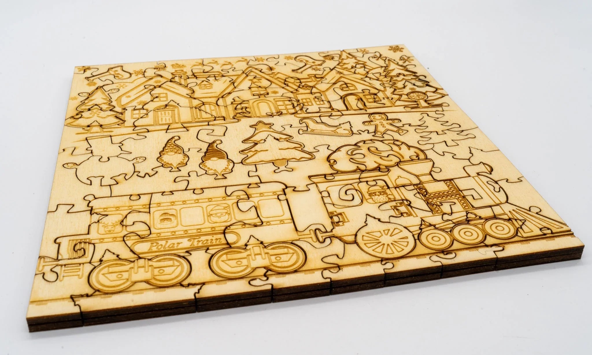 Wooden Christmas puzzle featuring a Polar Train, houses, trees, and festive engravings