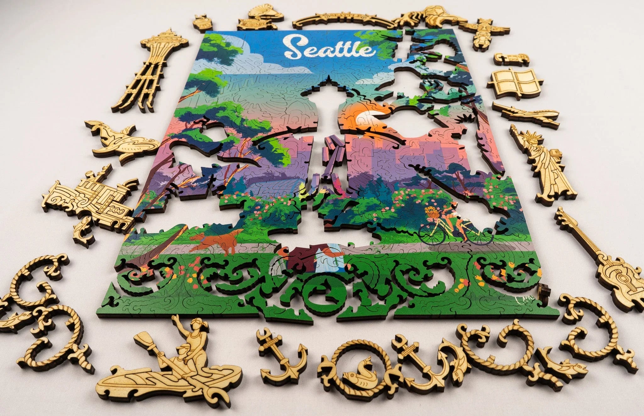 Colorful Seattle puzzle with intricate wooden pieces and city-themed shapes on white background.