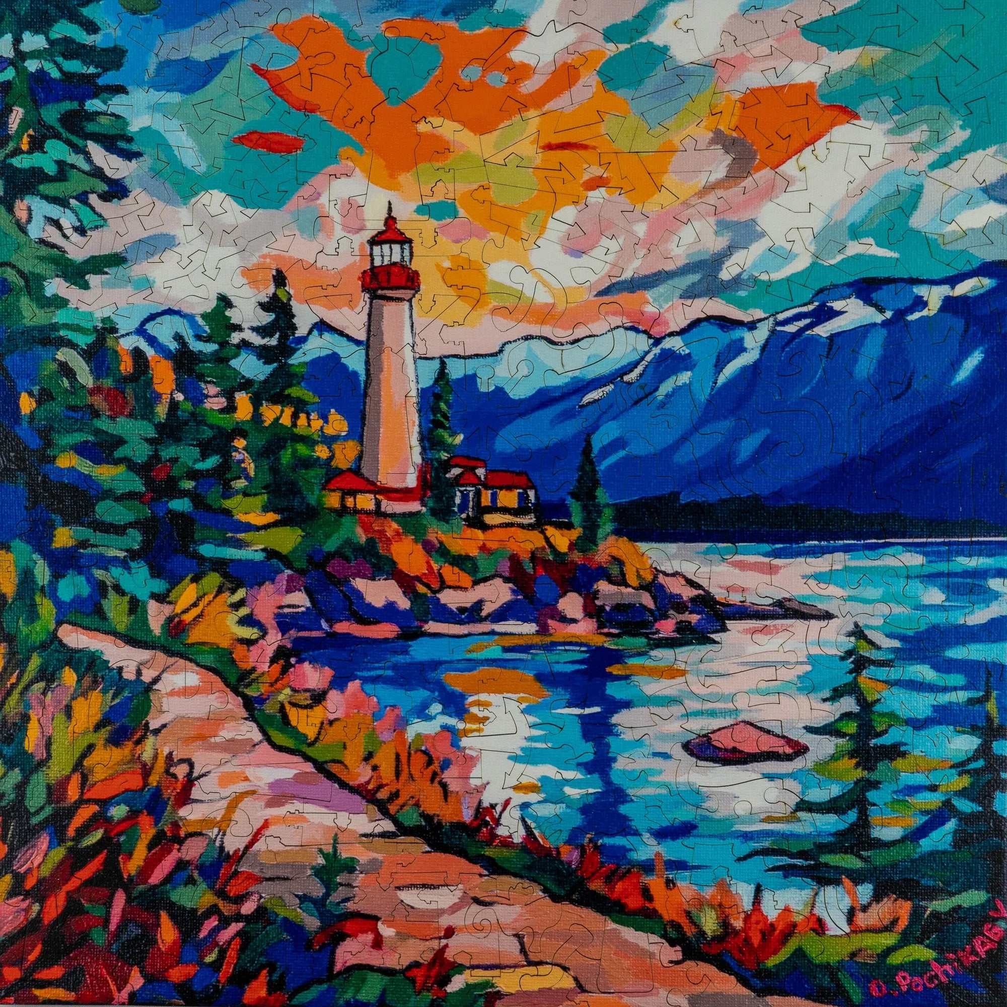 Colorful lighthouse landscape puzzle with mountains, lake, and vibrant sunset sky