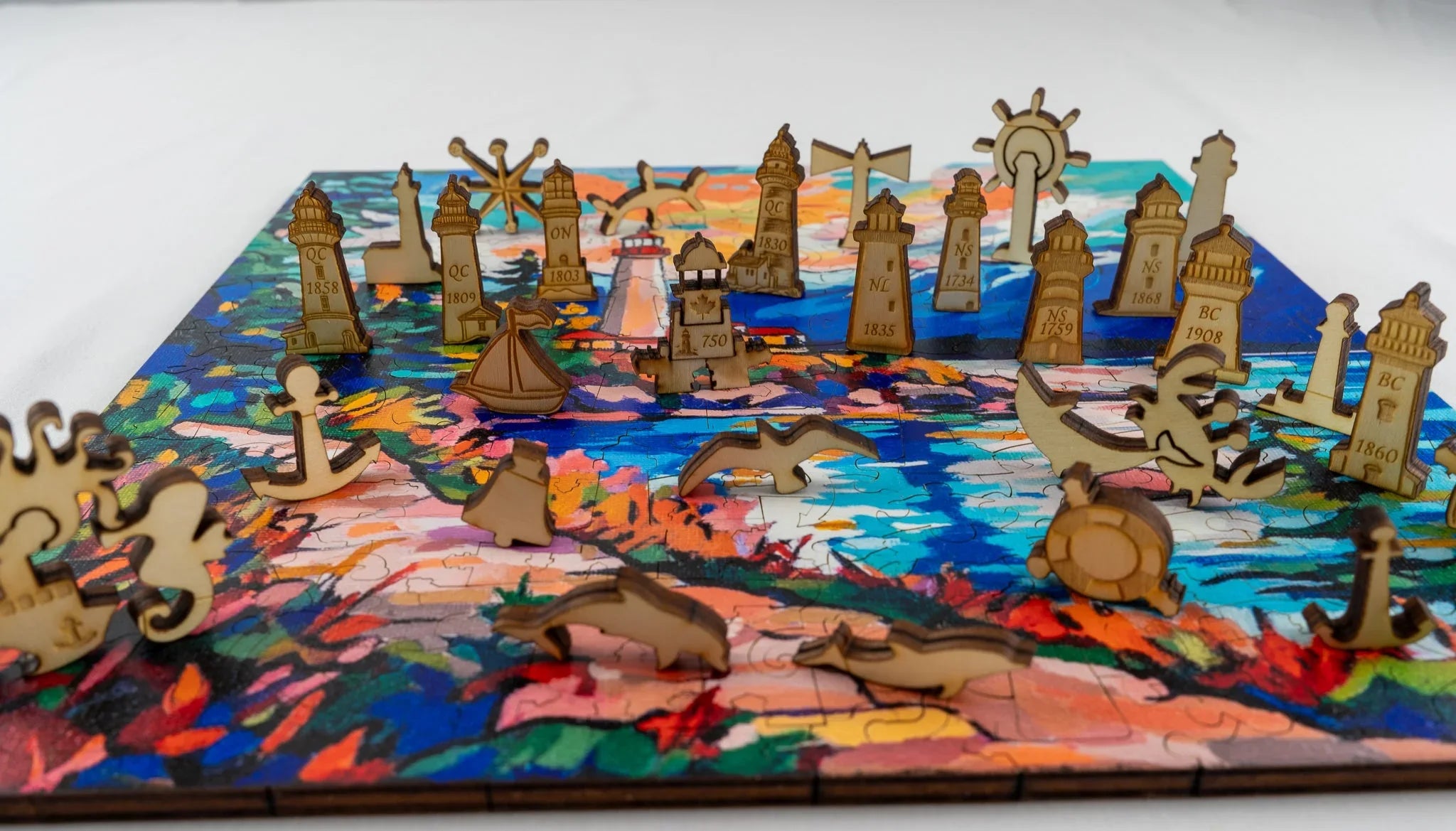 Colorful wooden puzzle featuring lighthouse and sea animal pieces on a painted ocean scene