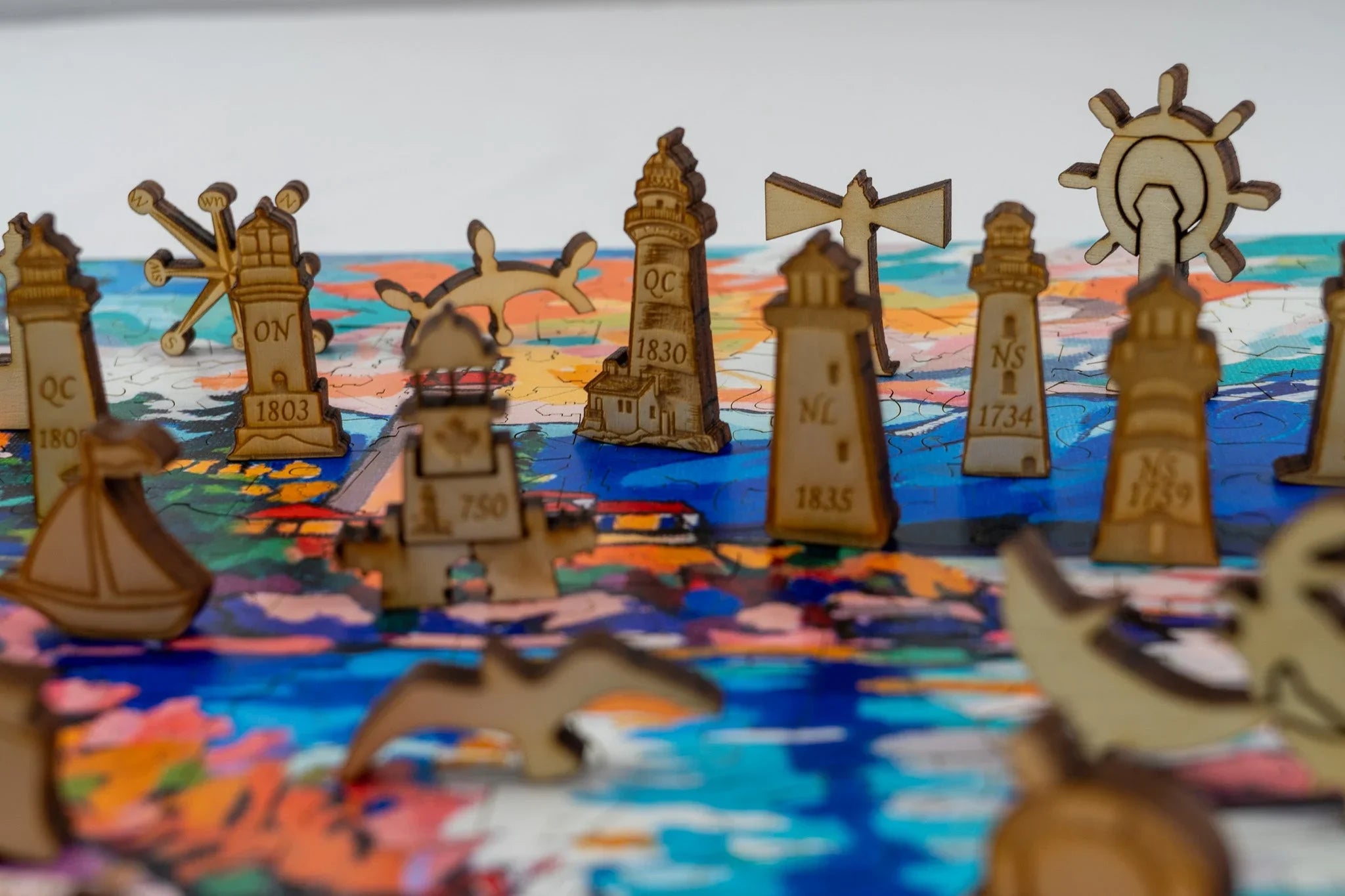 Wooden lighthouse puzzle pieces on a colorful map background, nautical theme