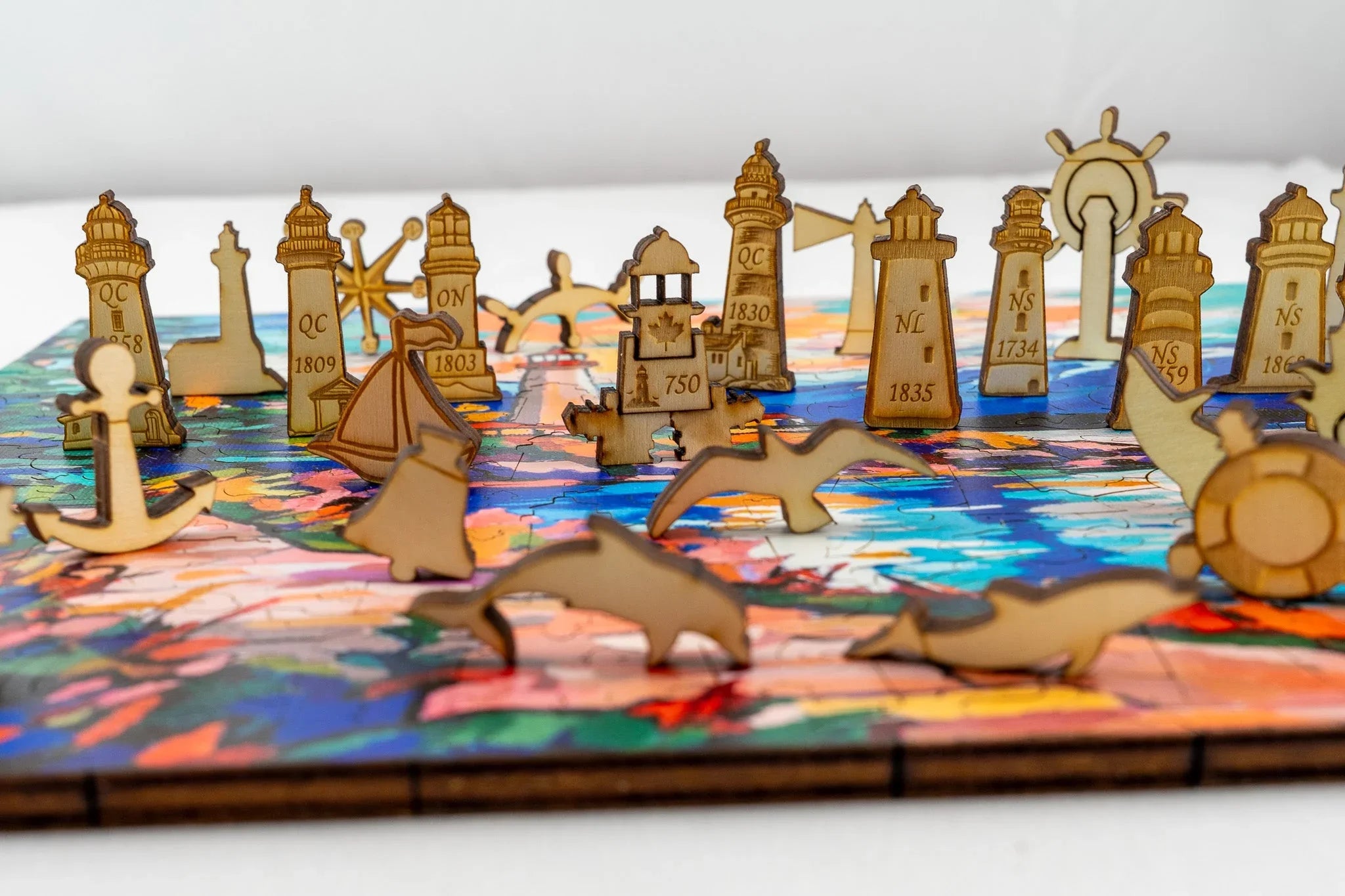 Wooden lighthouse puzzle pieces with nautical shapes on colorful background