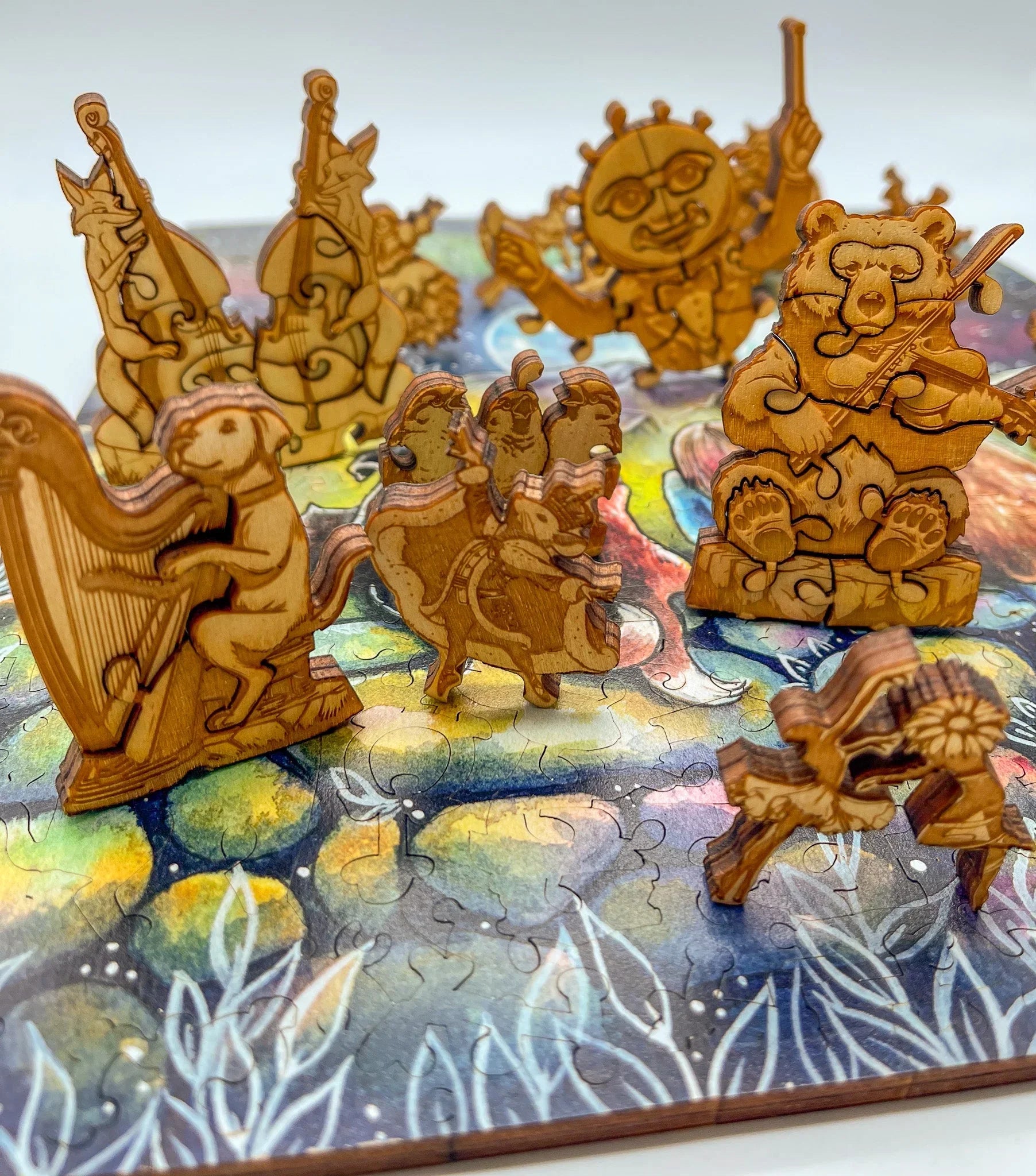 Wooden animal orchestra puzzle pieces on a colorful painted background