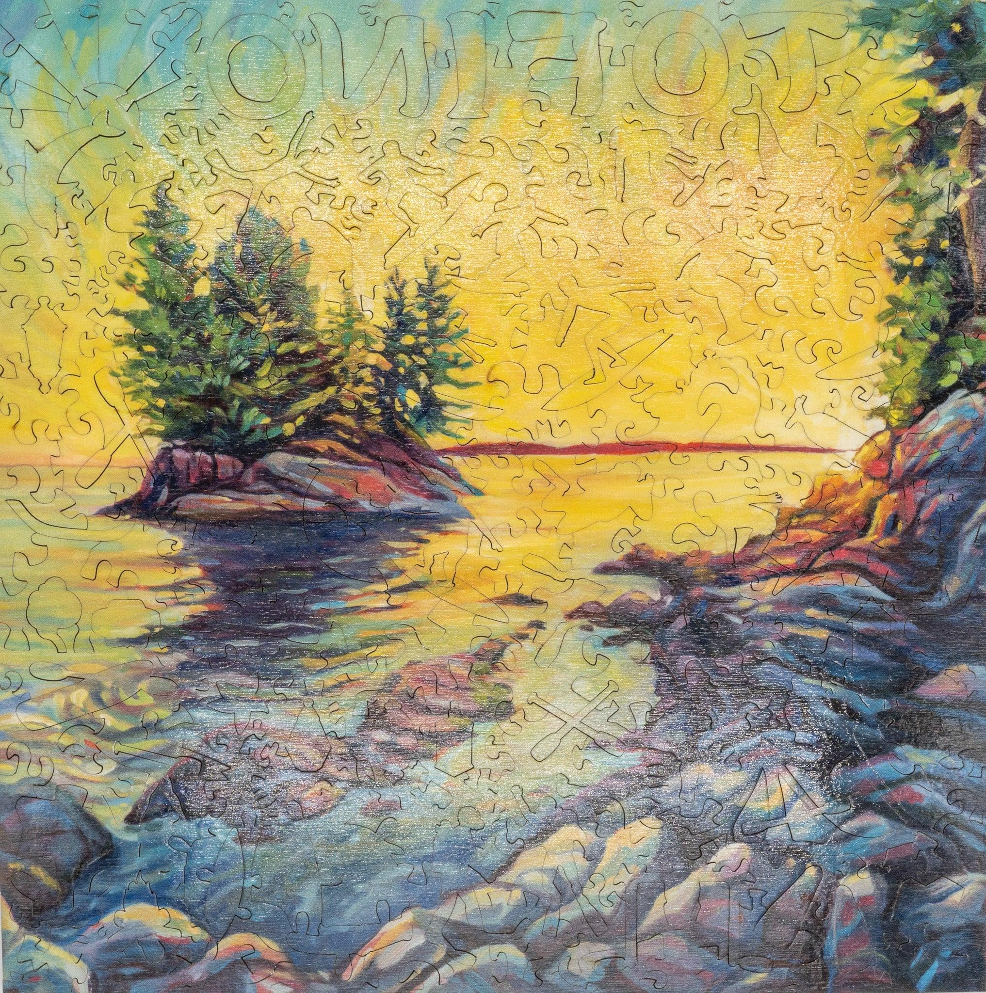 Colorful jigsaw puzzle of a rocky shoreline with pine trees and vibrant sunset over the water
