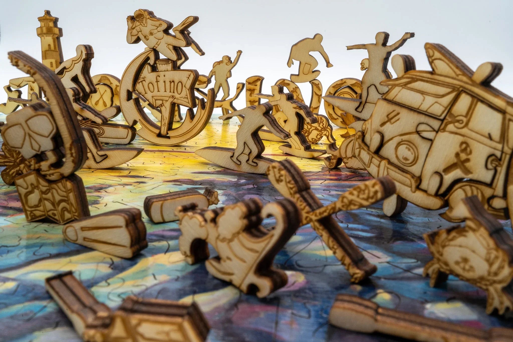 Tofino wooden puzzle pieces featuring surfers, surfboards, van, and lighthouse details