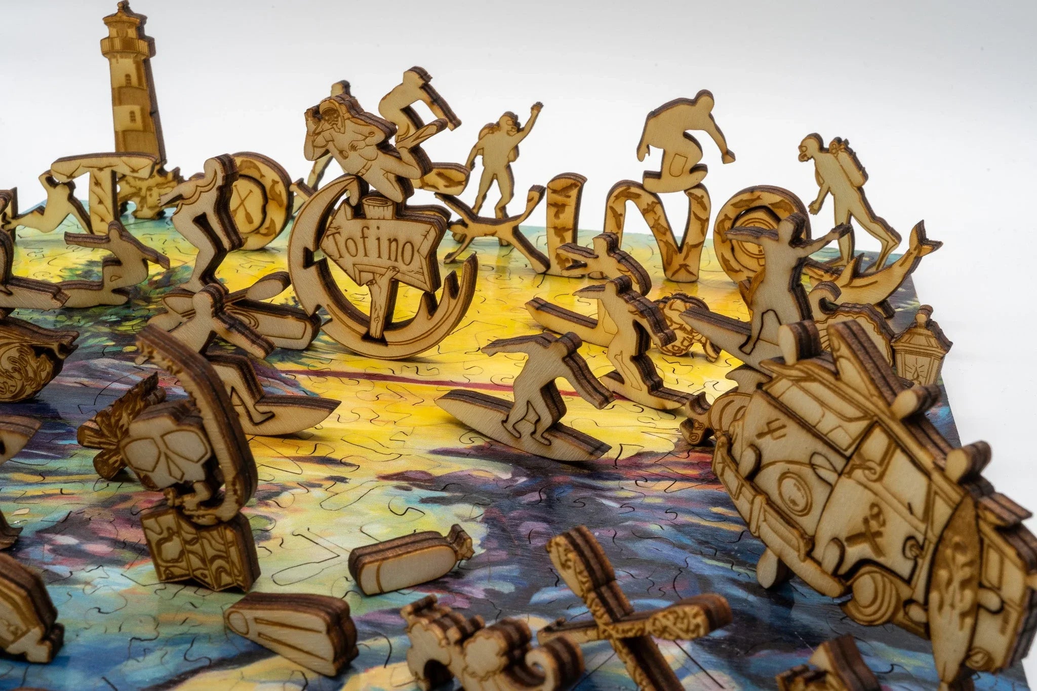 Wooden Tofino-themed puzzle pieces with surfers, lighthouse, van, and ocean scene background