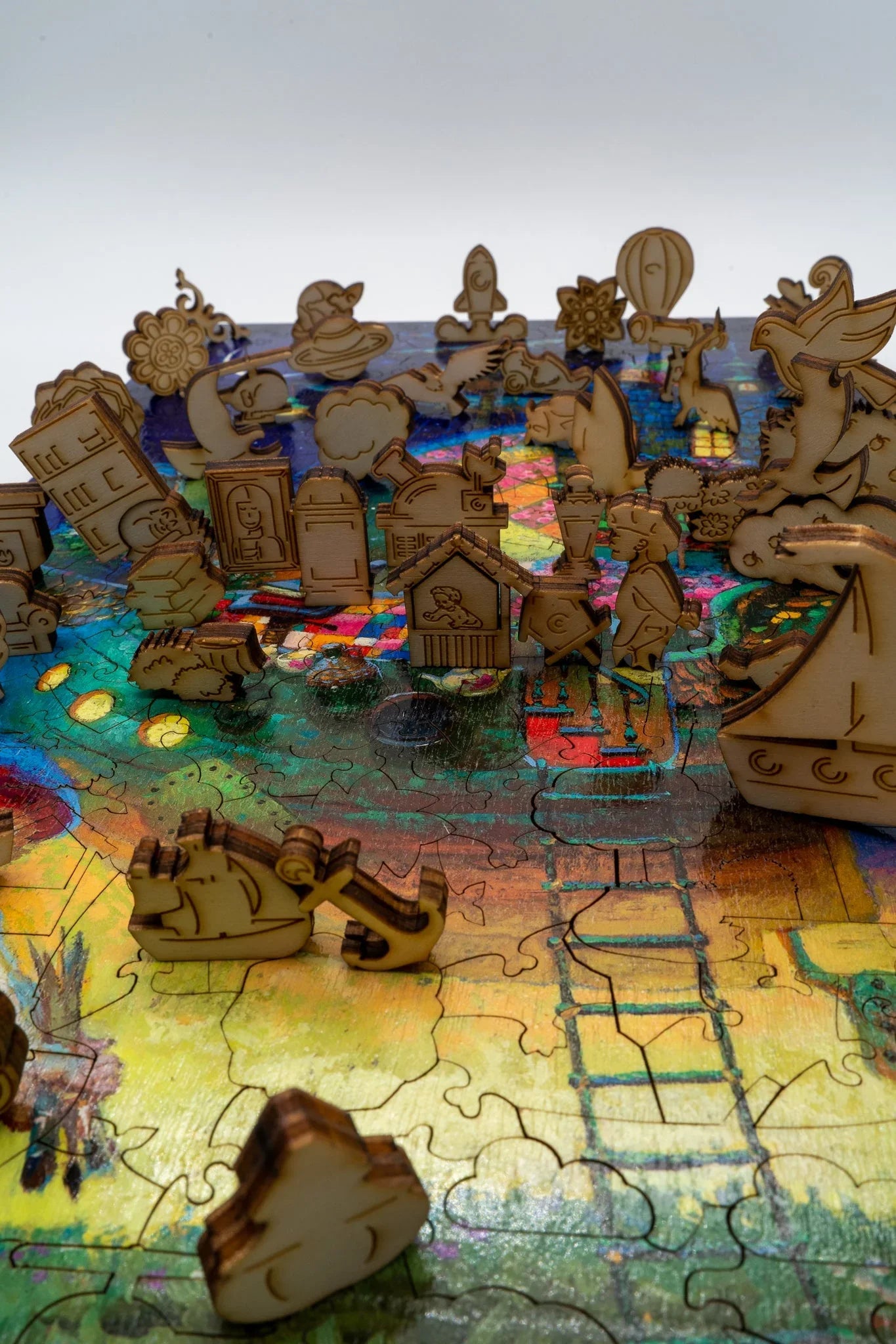 Colorful jigsaw puzzle with whimsical wooden pieces shaped like buildings, animals, and objects