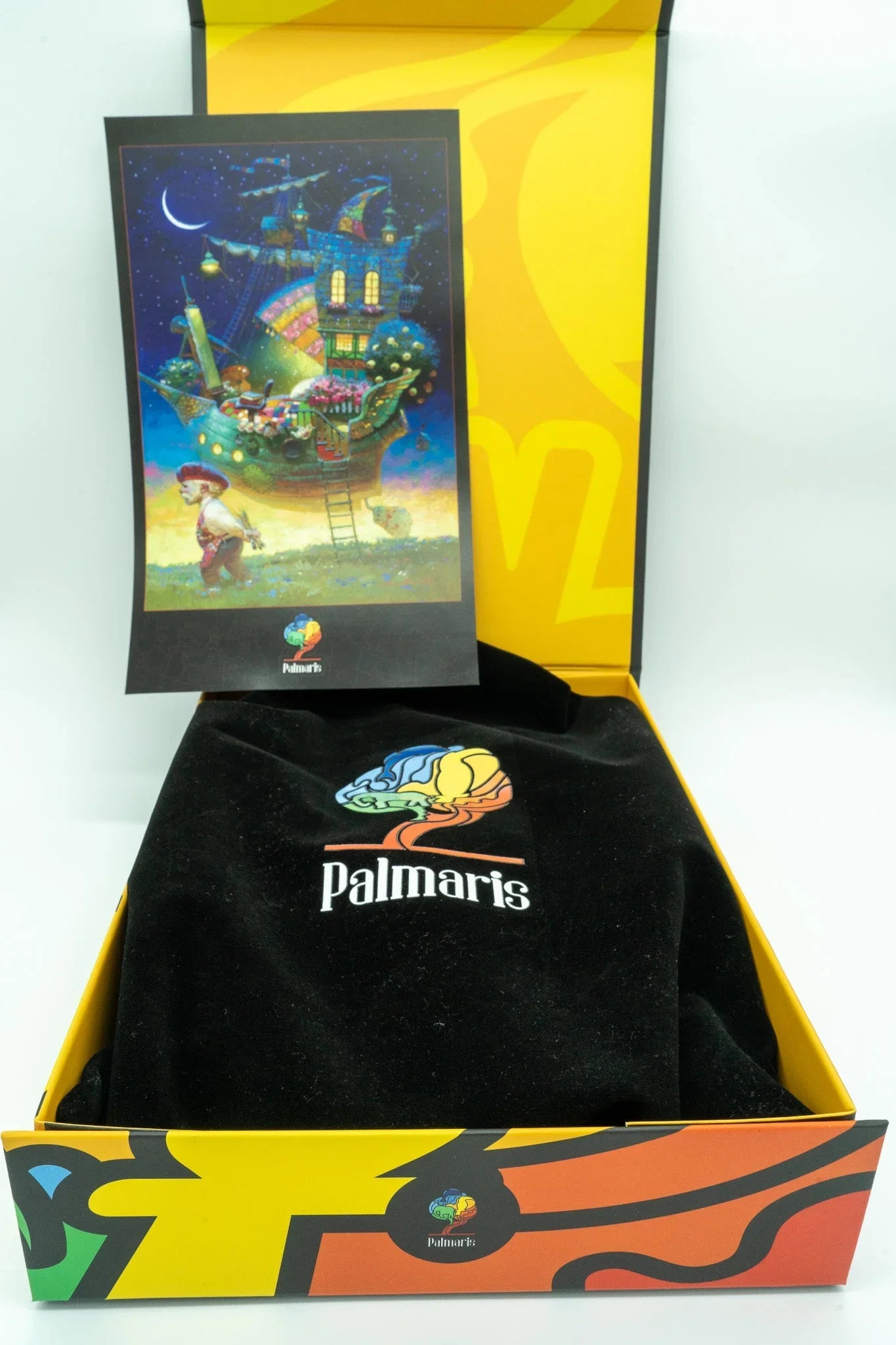 Palmaris gift box with colorful fantasy art card and branded black cloth inside yellow packaging