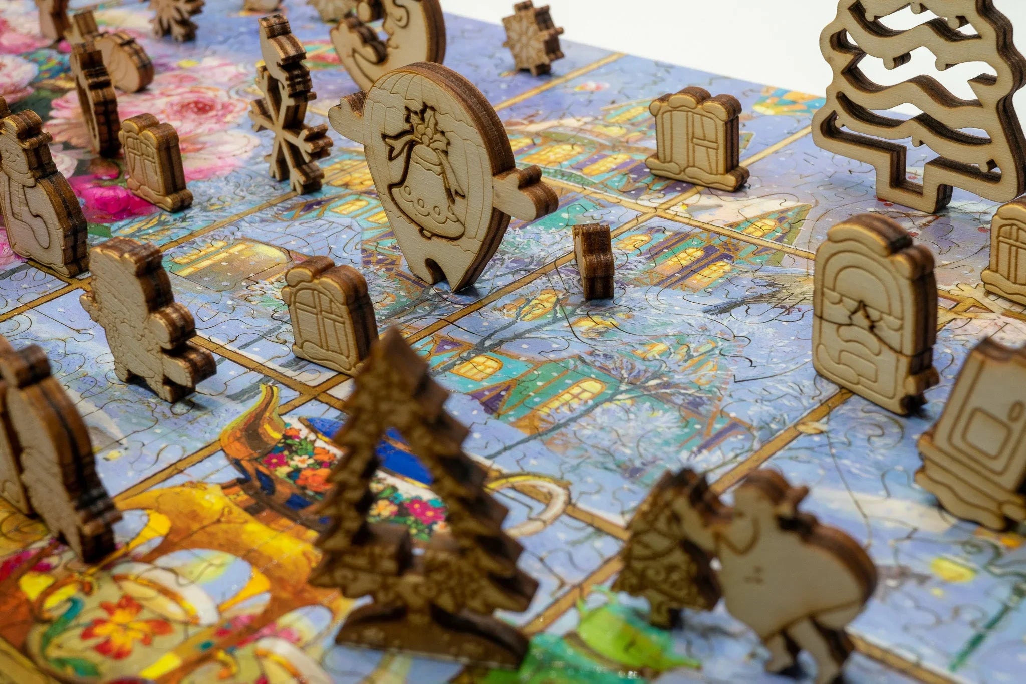 Wooden Christmas-themed puzzle pieces on a colorful holiday jigsaw puzzle