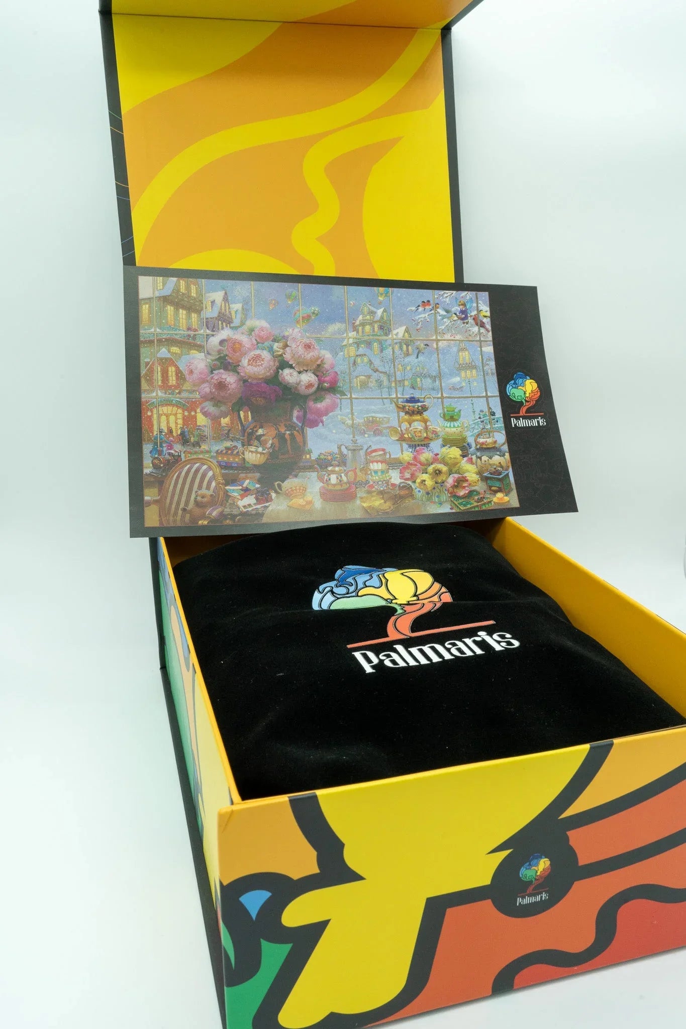 Palmari's colorful gift box with branded black pouch and art card inside packaging.