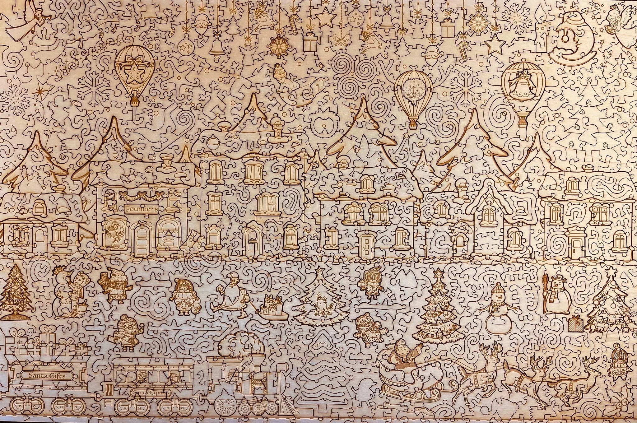 Wooden Christmas village puzzle with engraved festive houses, Santa, reindeer, trees, and holiday decorations