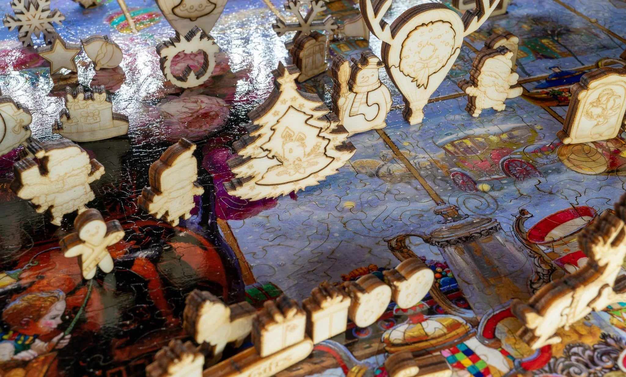 Wooden Christmas puzzle pieces on a colorful holiday-themed jigsaw puzzle table