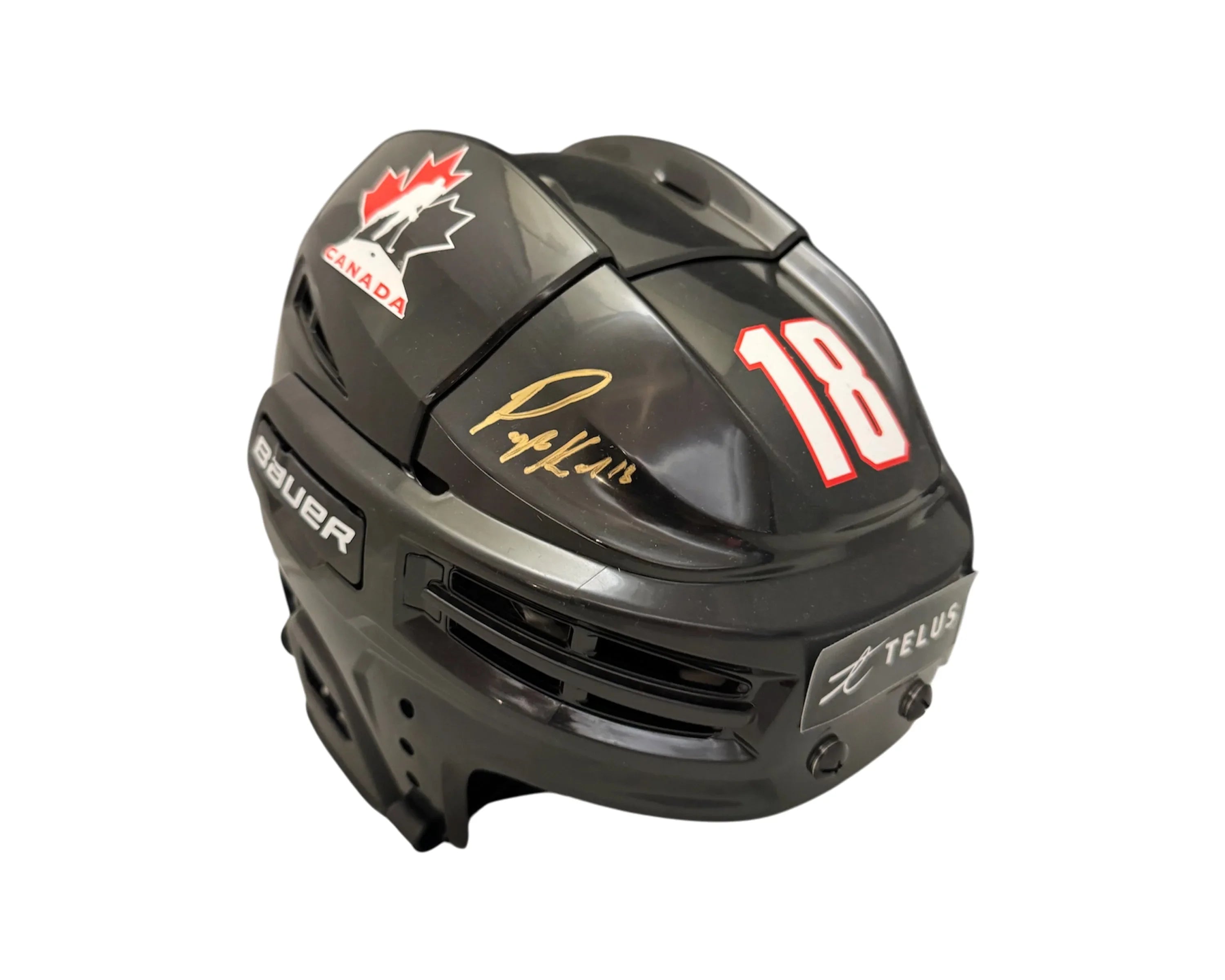 Team Canada black Bauer hockey helmet with number 18, Telus logo, and gold autograph.
