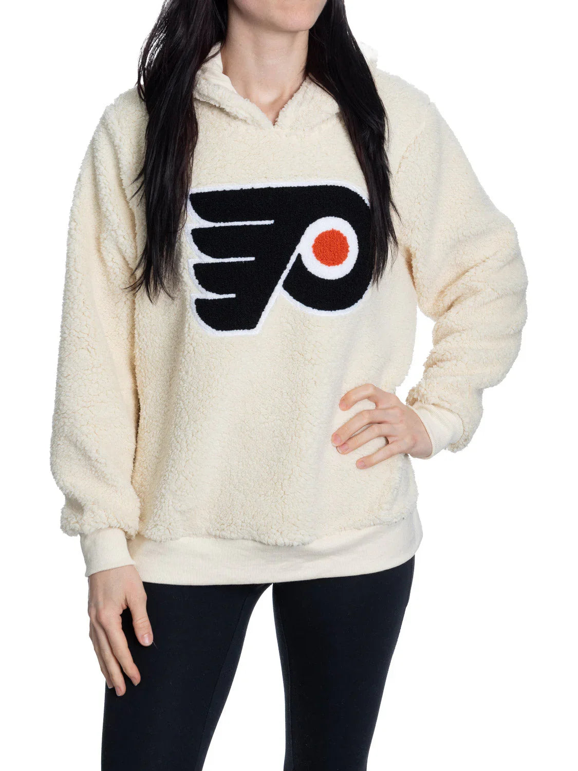 Woman wearing cream sherpa hoodie with Philadelphia Flyers logo
