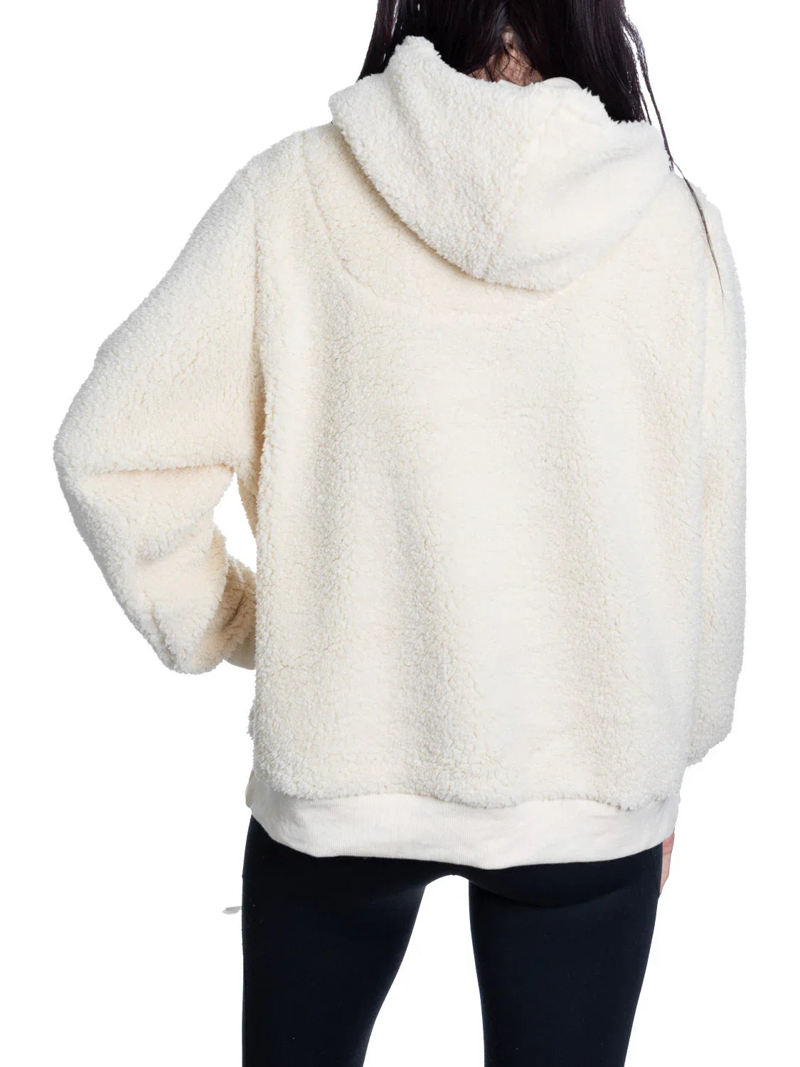Back view of woman wearing cream sherpa fleece hoodie and black leggings
