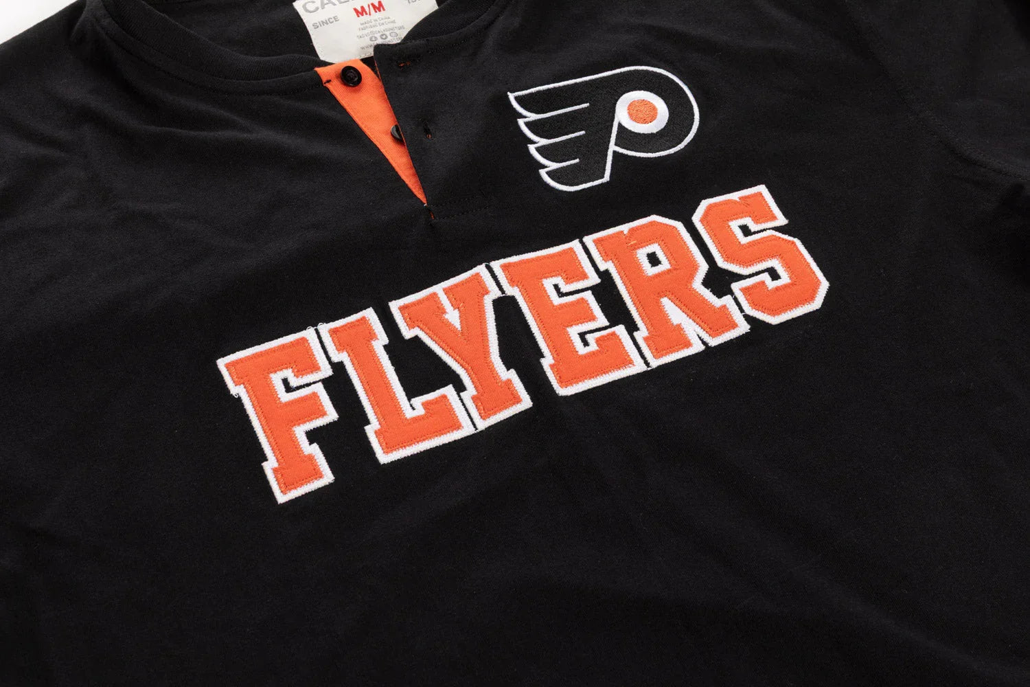 Black henley shirt with orange Flyers text and hockey logo embroidered on chest
