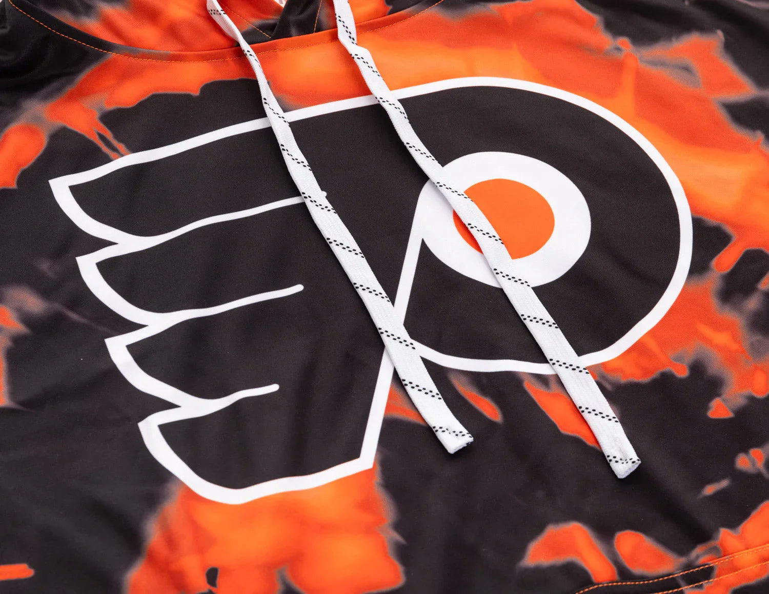 Close-up sublimation hoodie with orange black Flyers logo and white drawstrings