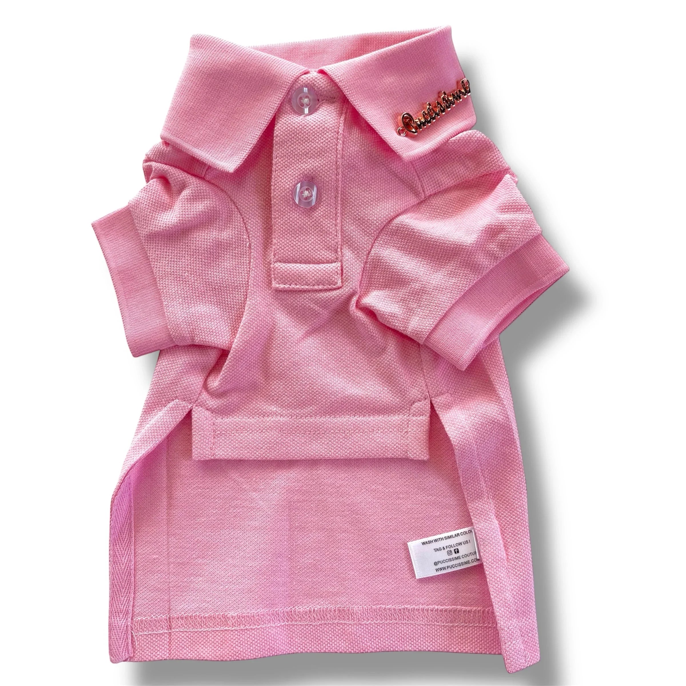 Pink dog polo shirt with collar, buttons, and gold embellishment on the neck