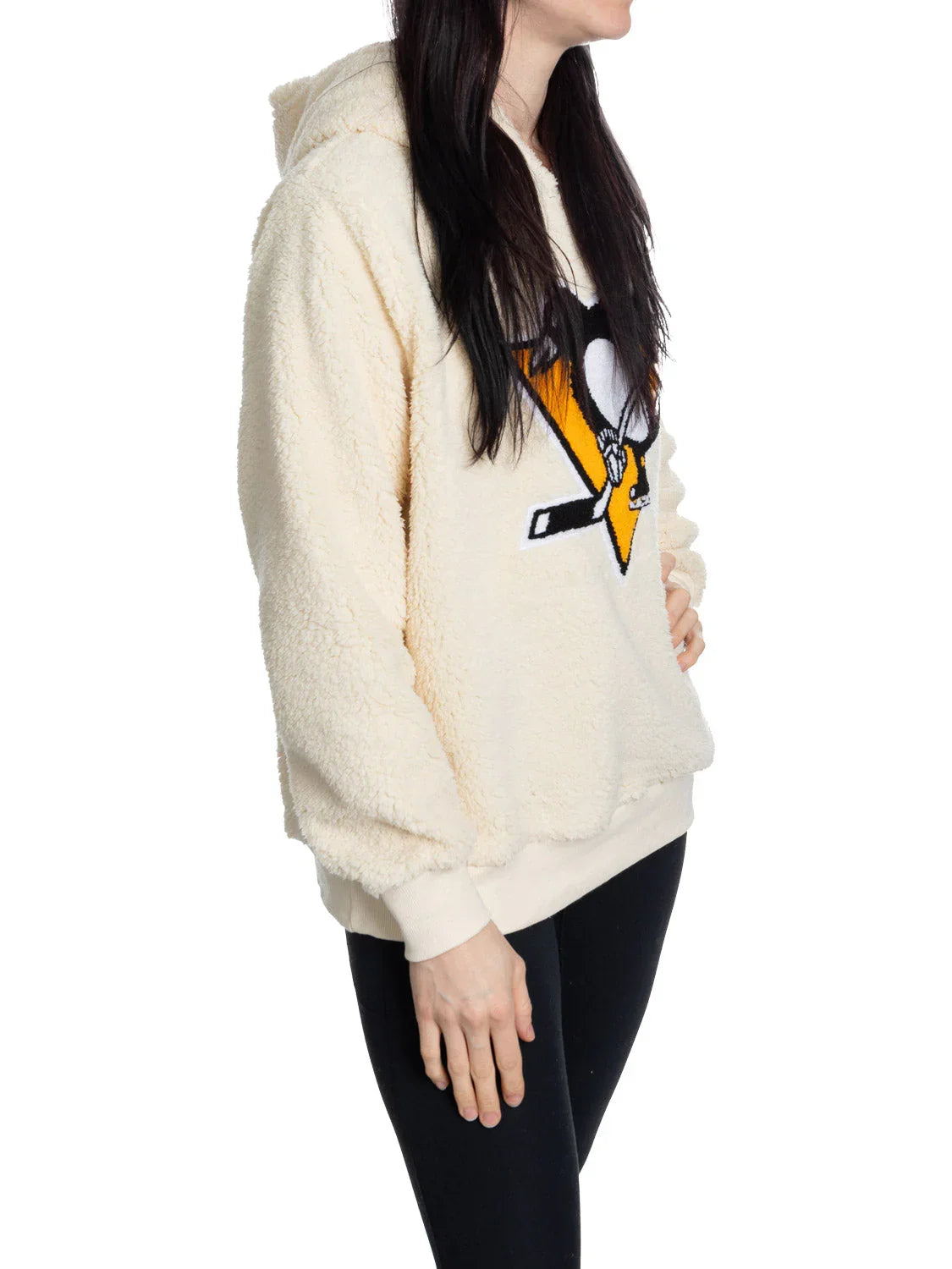 Woman wearing cream sherpa hoodie with Pittsburgh Penguins logo on front