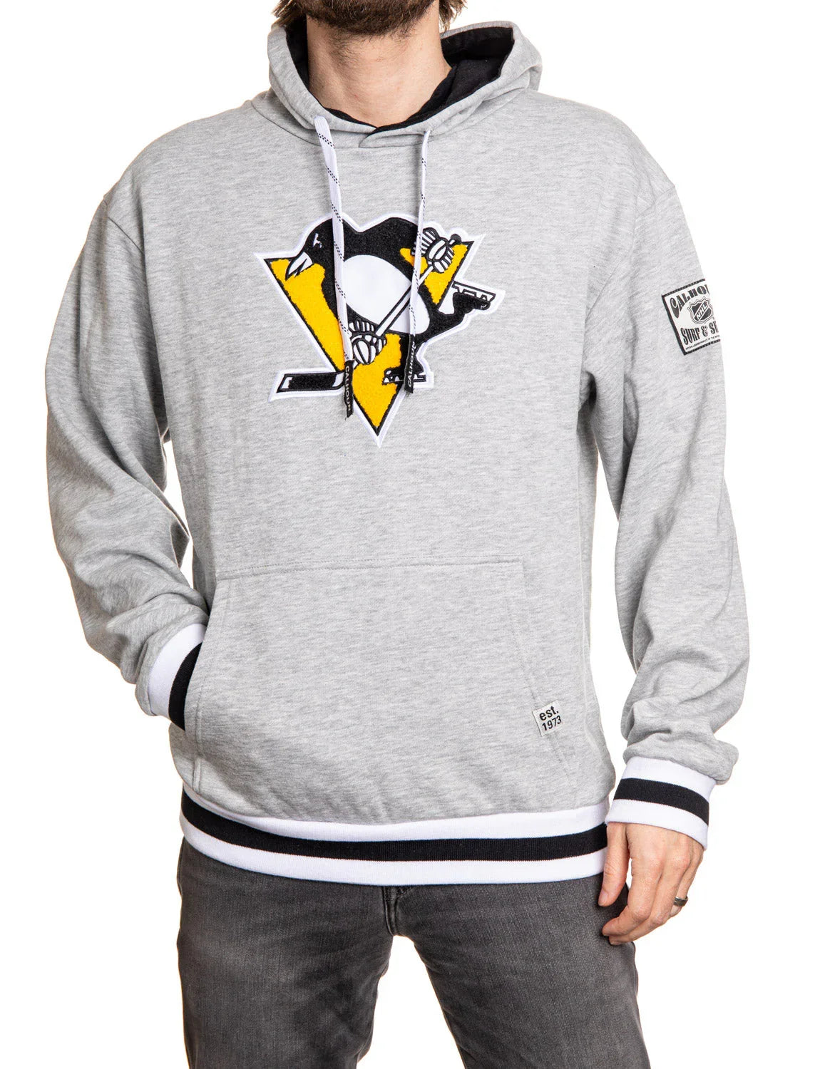 Grey Pittsburgh Penguins chenille logo hoodie with black and white trim worn by man