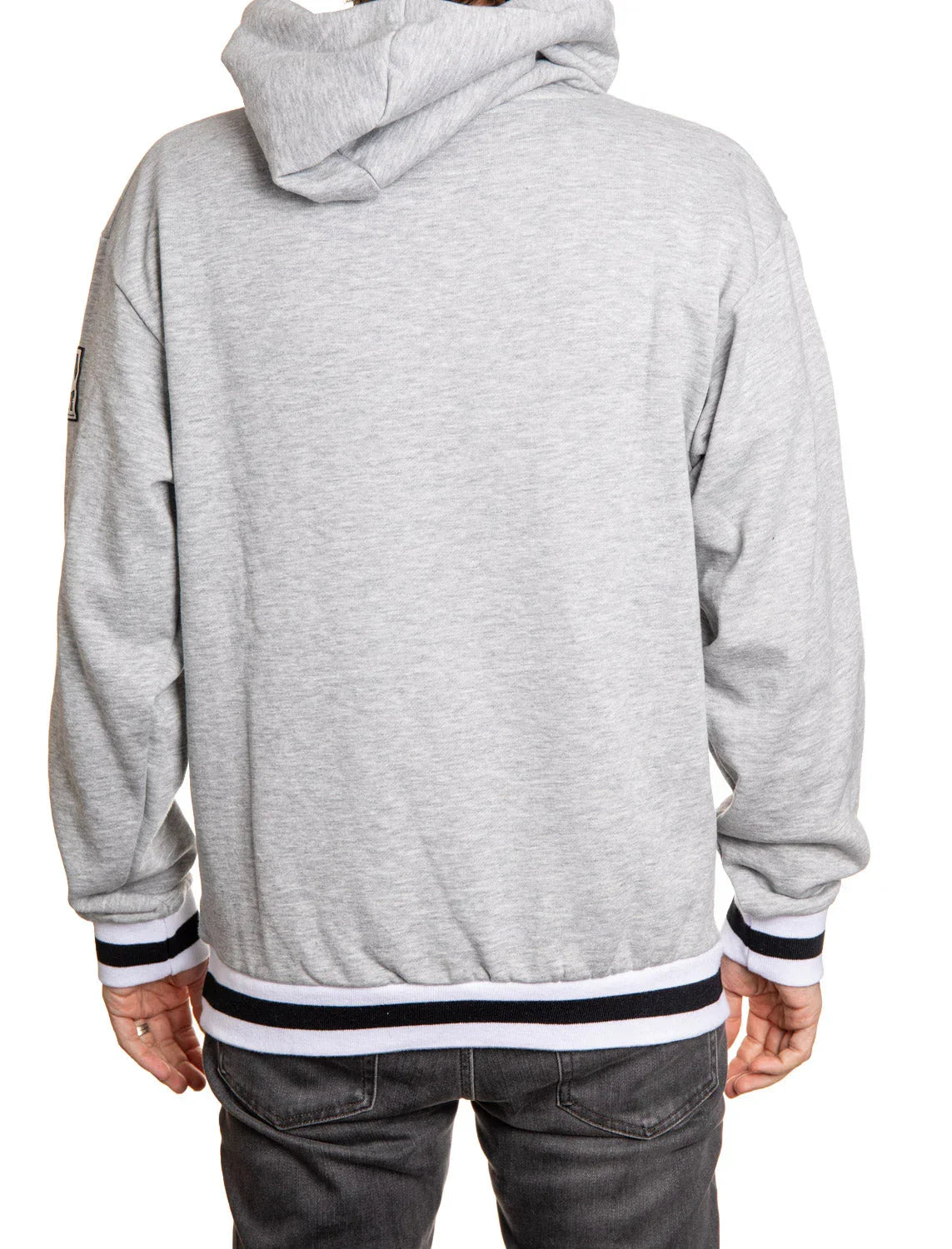 Back view of person wearing a light grey hoodie with striped cuffs and waistband