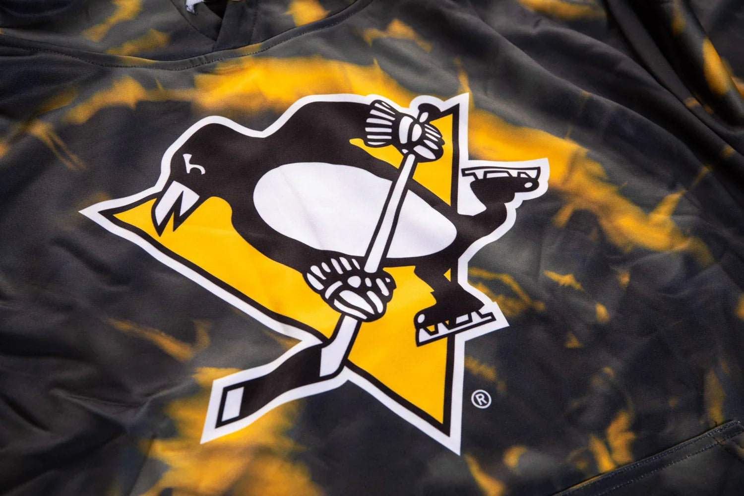 Pittsburgh Penguins logo on black and yellow sublimated hockey hoodie fabric