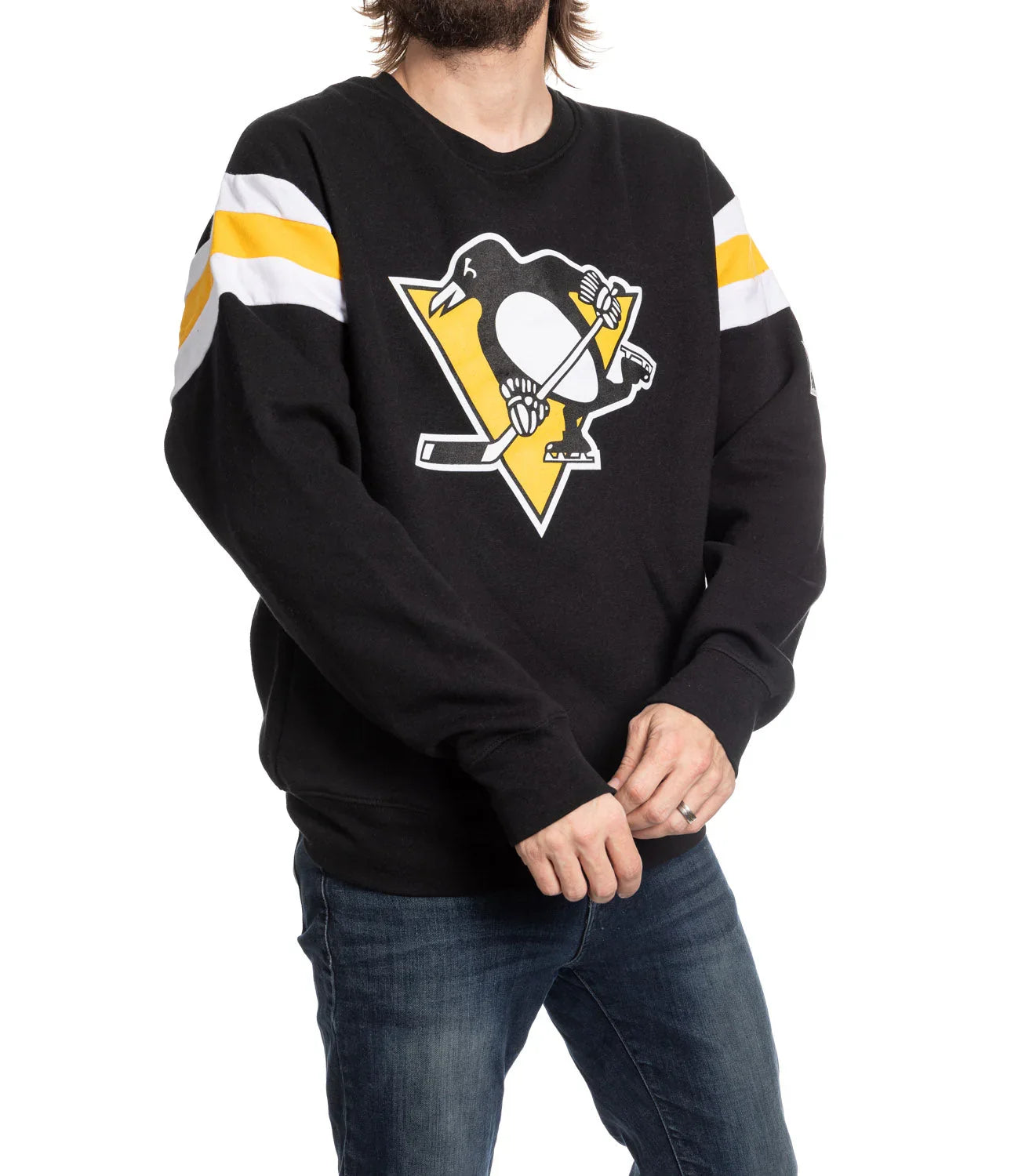 Man wearing black Pittsburgh Penguins varsity sweater with logo and striped sleeves