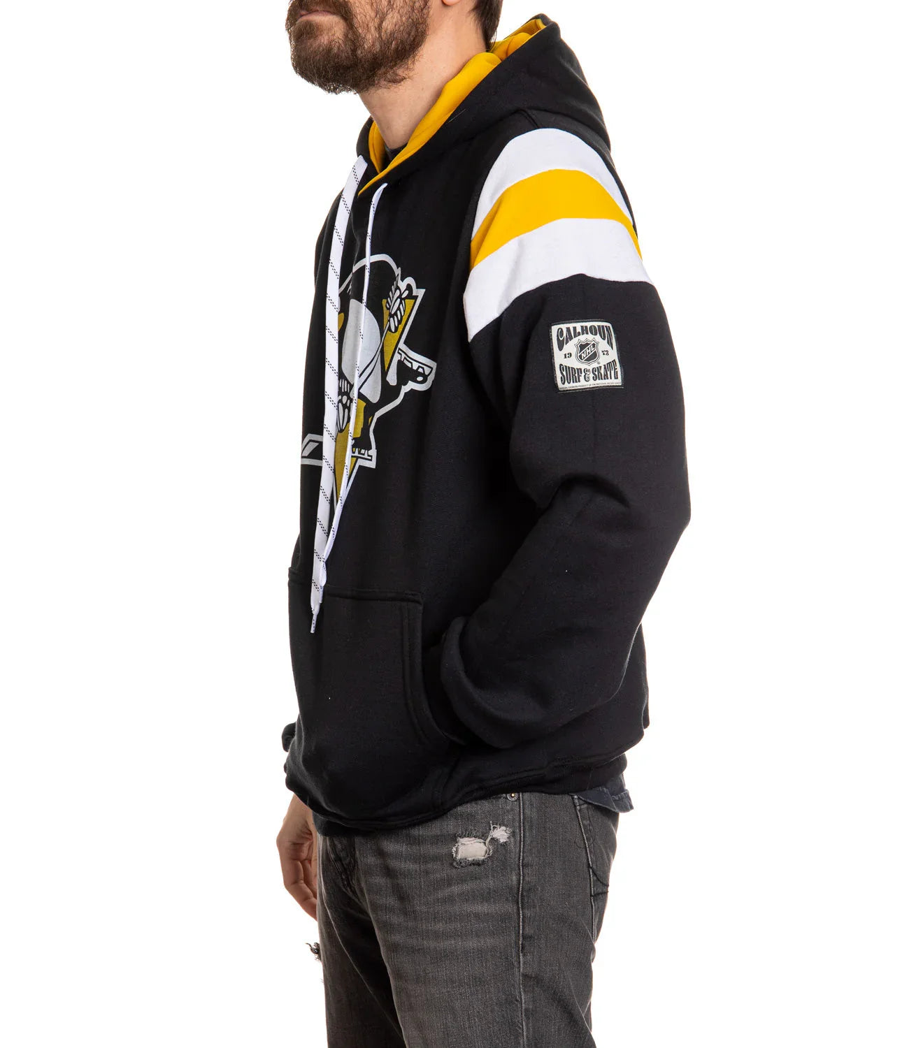 Man wearing black Pittsburgh Penguins hoodie with yellow and white stripes, Calhoun patch