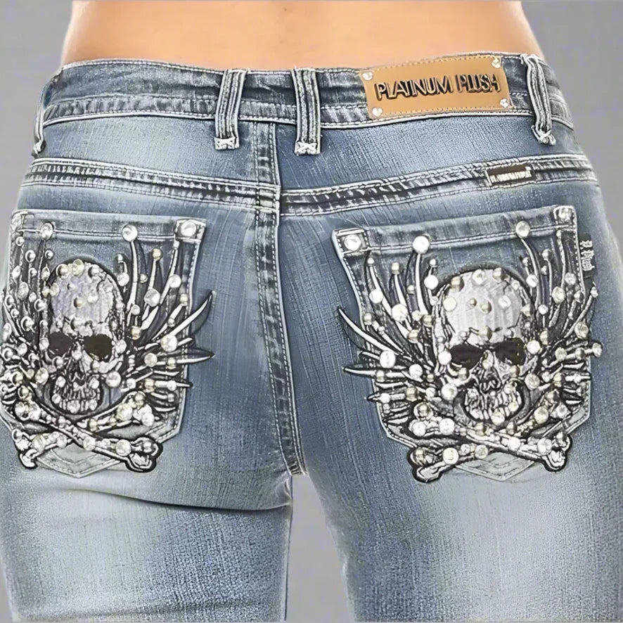 Women's blue jeans with skull and bone stitch designs on back pockets, Platinum Plush label