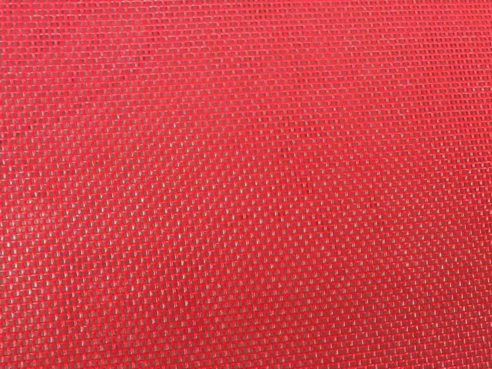 Close-up of bright red poolside hammock fabric with a woven texture