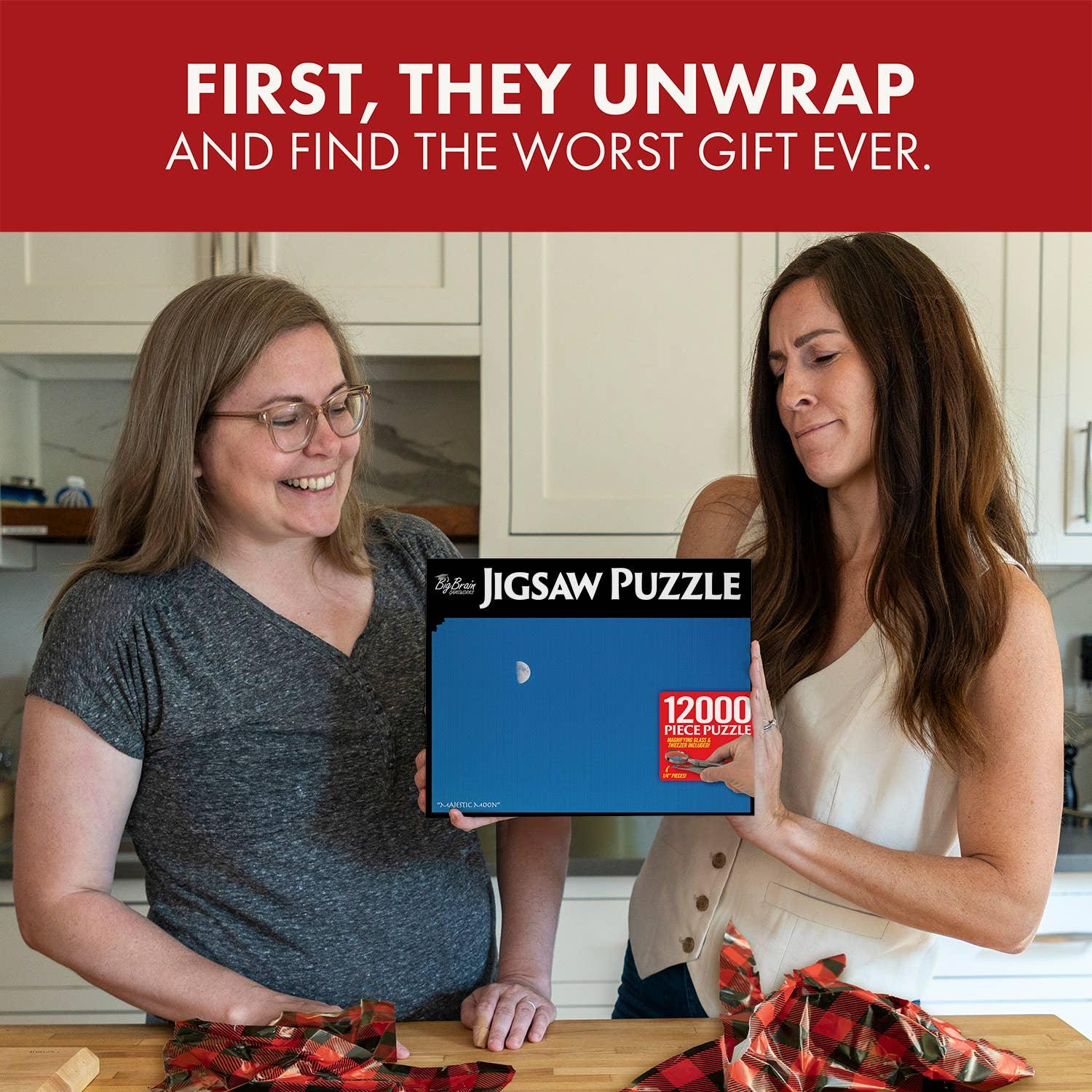 Two women in a kitchen, one holding a 12000 piece jigsaw puzzle gift with a plain blue design.