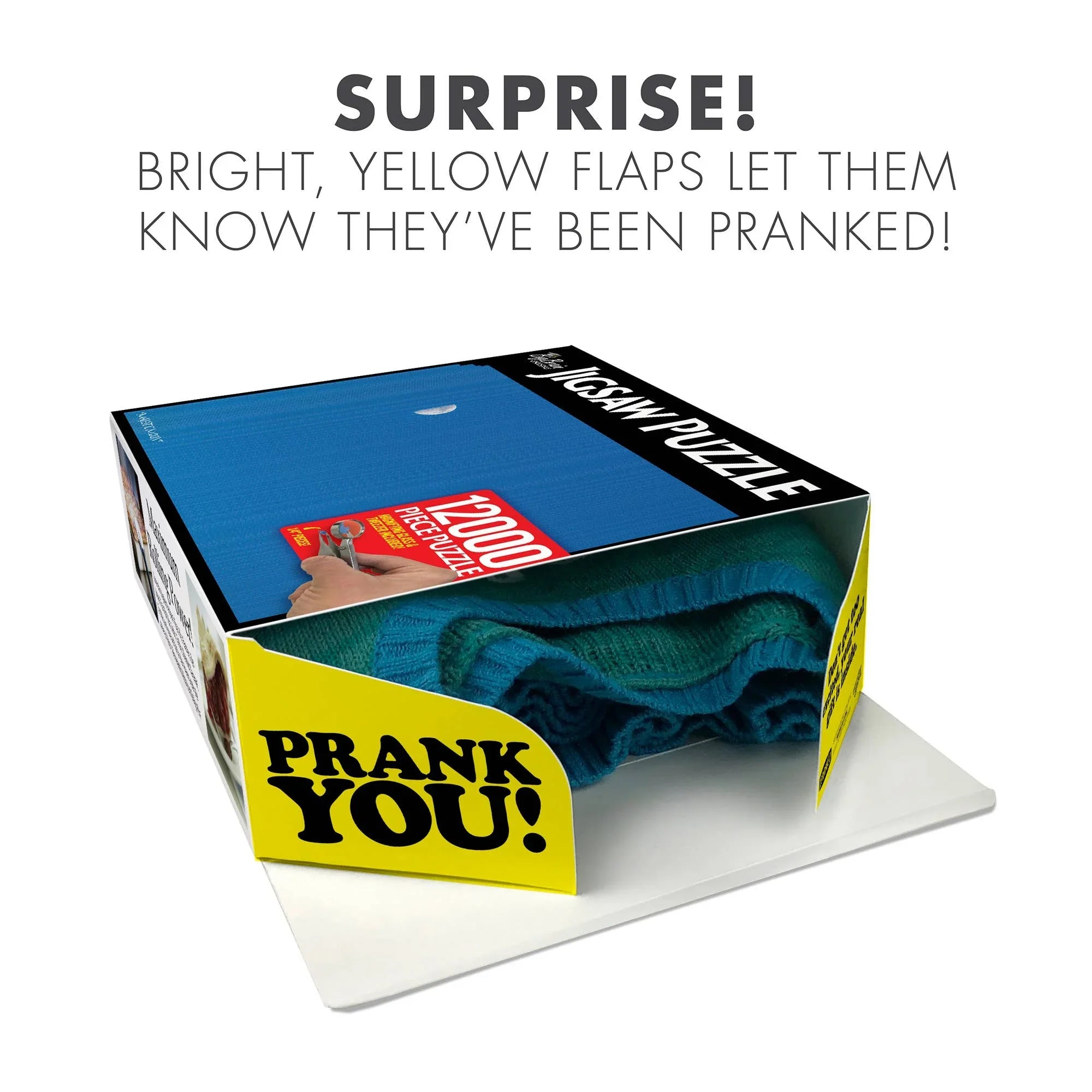 Prank jigsaw puzzle box with yellow 'PRANK YOU!' flap and blue cloth inside.