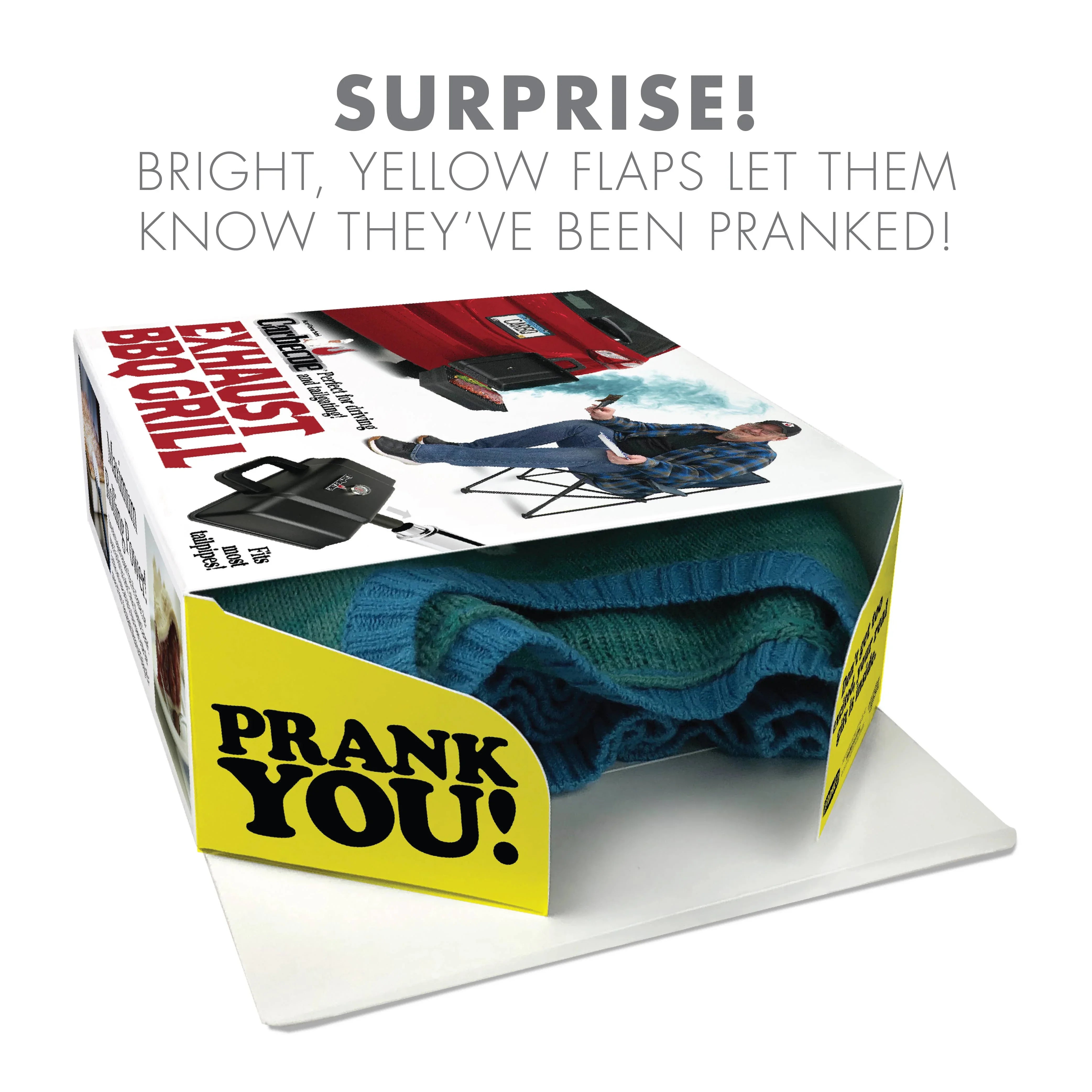 Prank gift box with bright yellow flaps, text 'PRANK YOU!', blue folded sweater inside, fake BBQ grill packaging